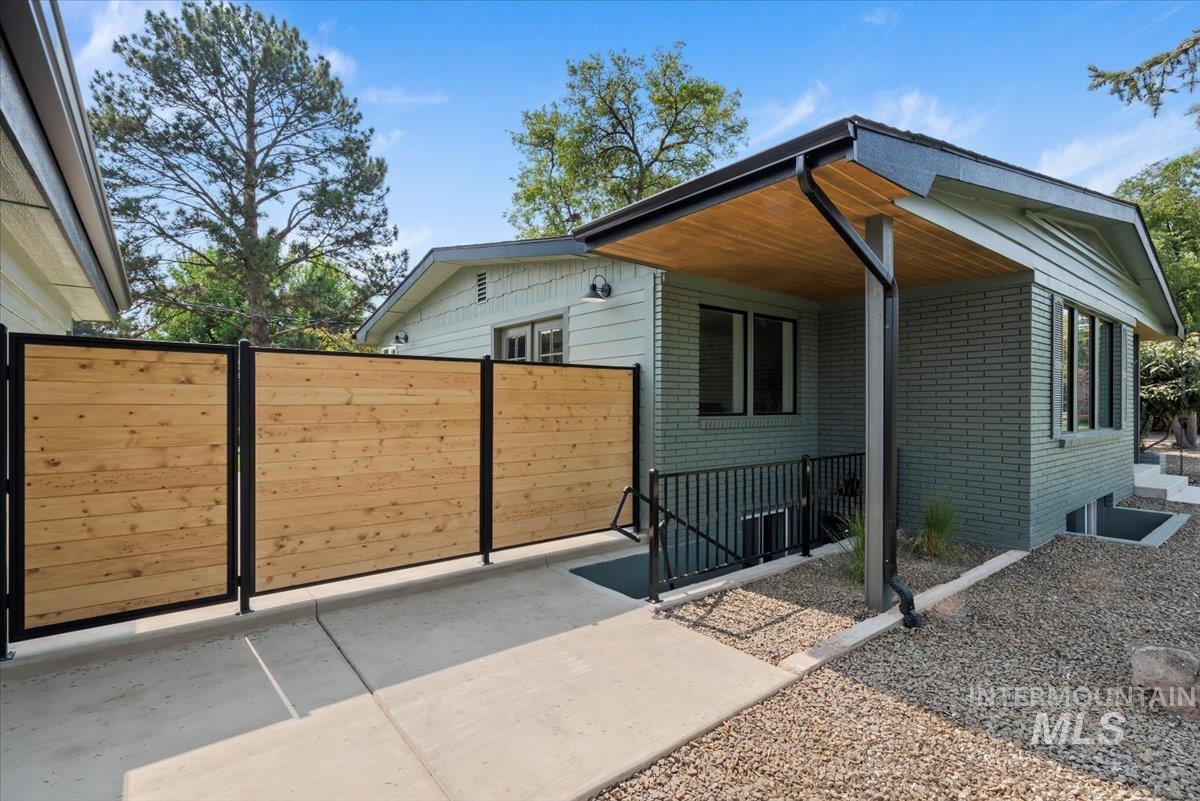 Exterior space with brick siding and a patio area