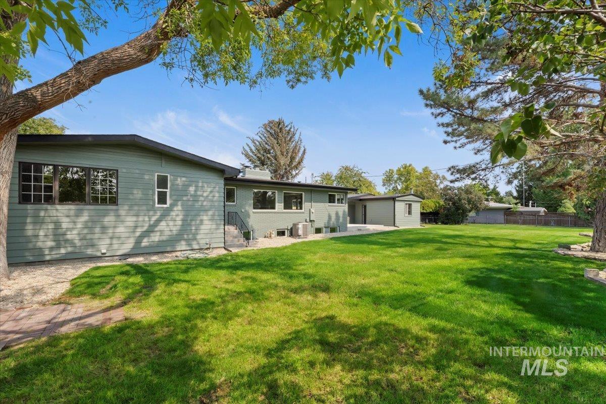 Back of property with a patio and an outdoor structure