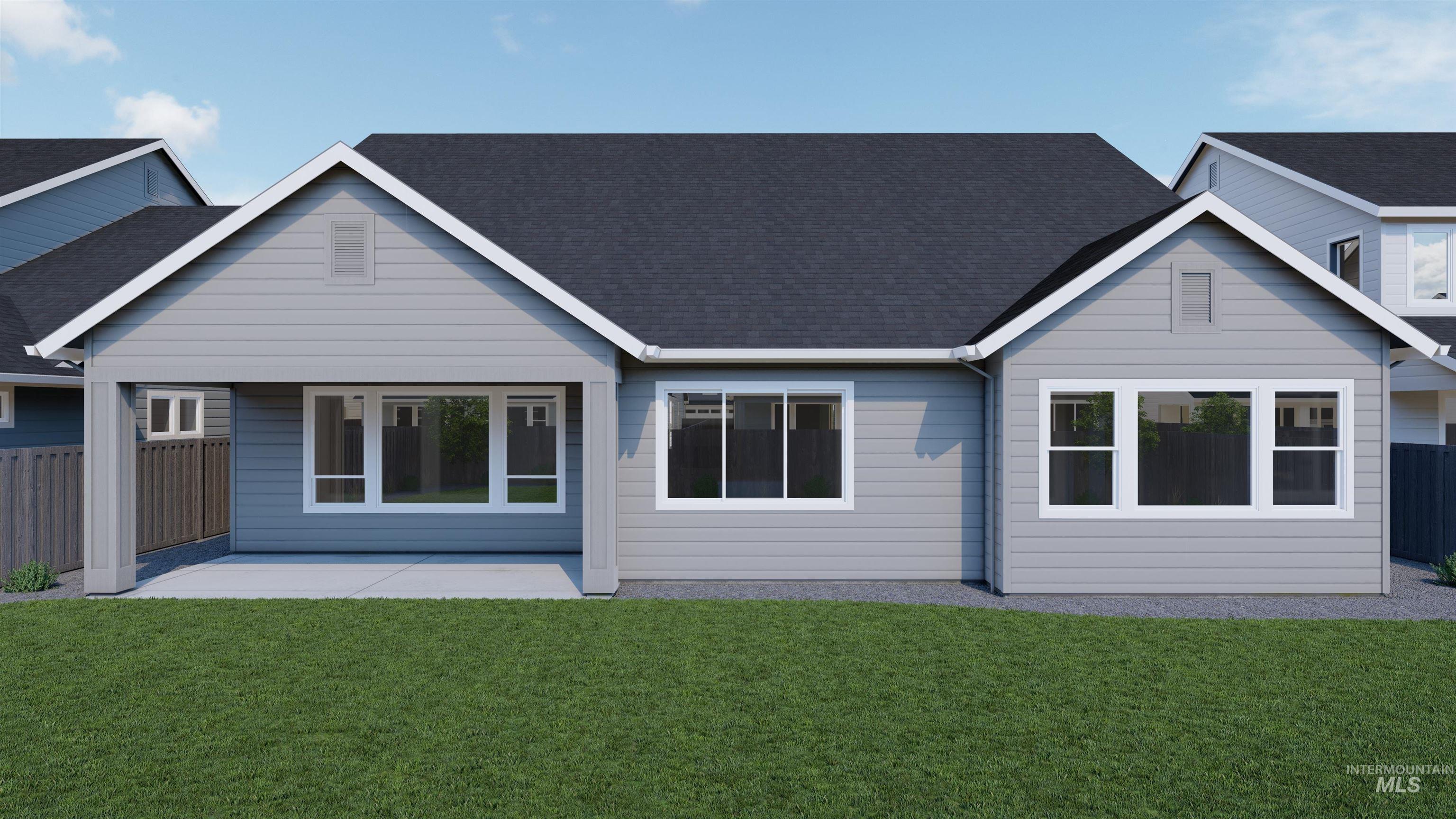 Rear view of house with a shingled roof and a patio
