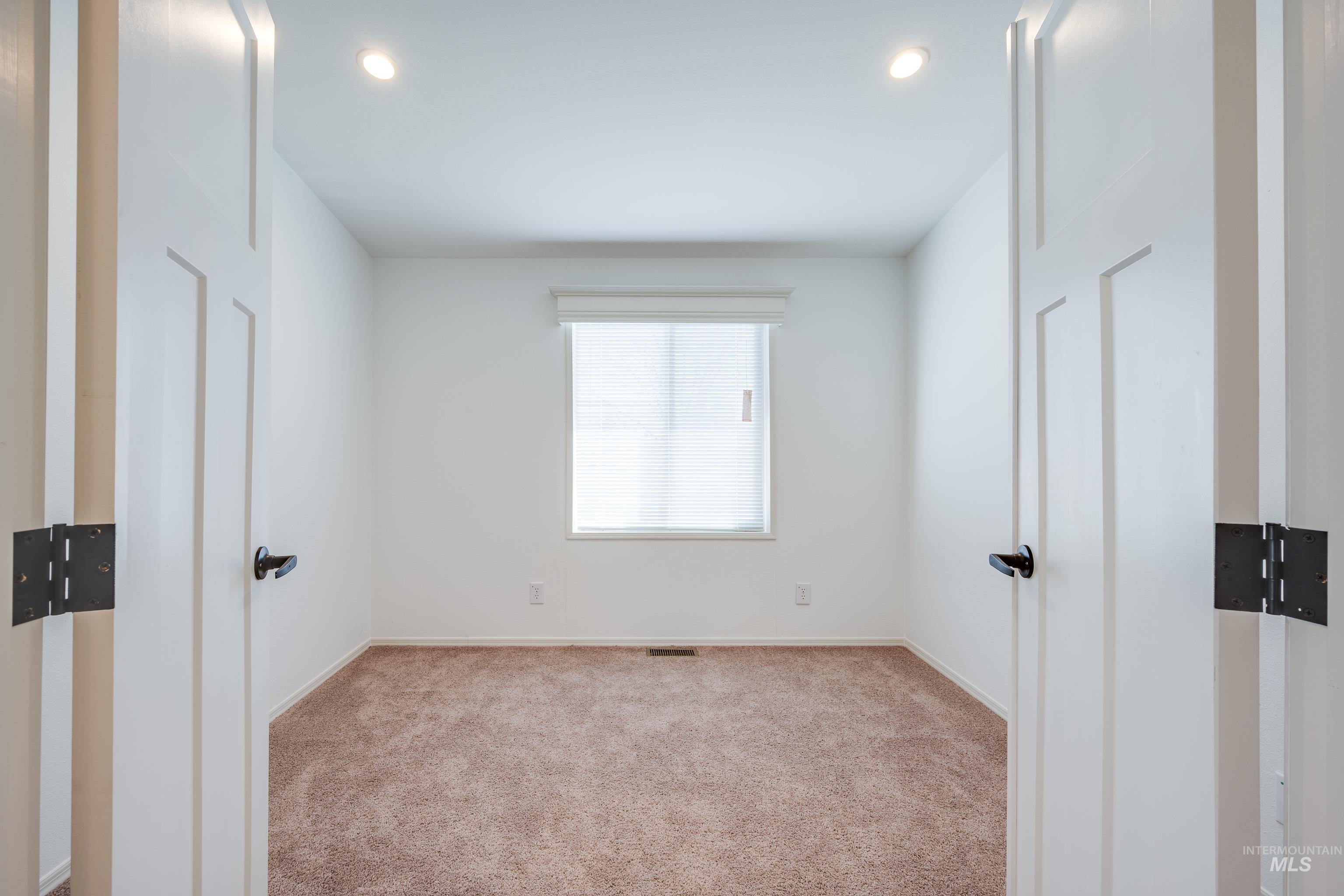 Unfurnished bedroom featuring light colored carpet and recessed lighting