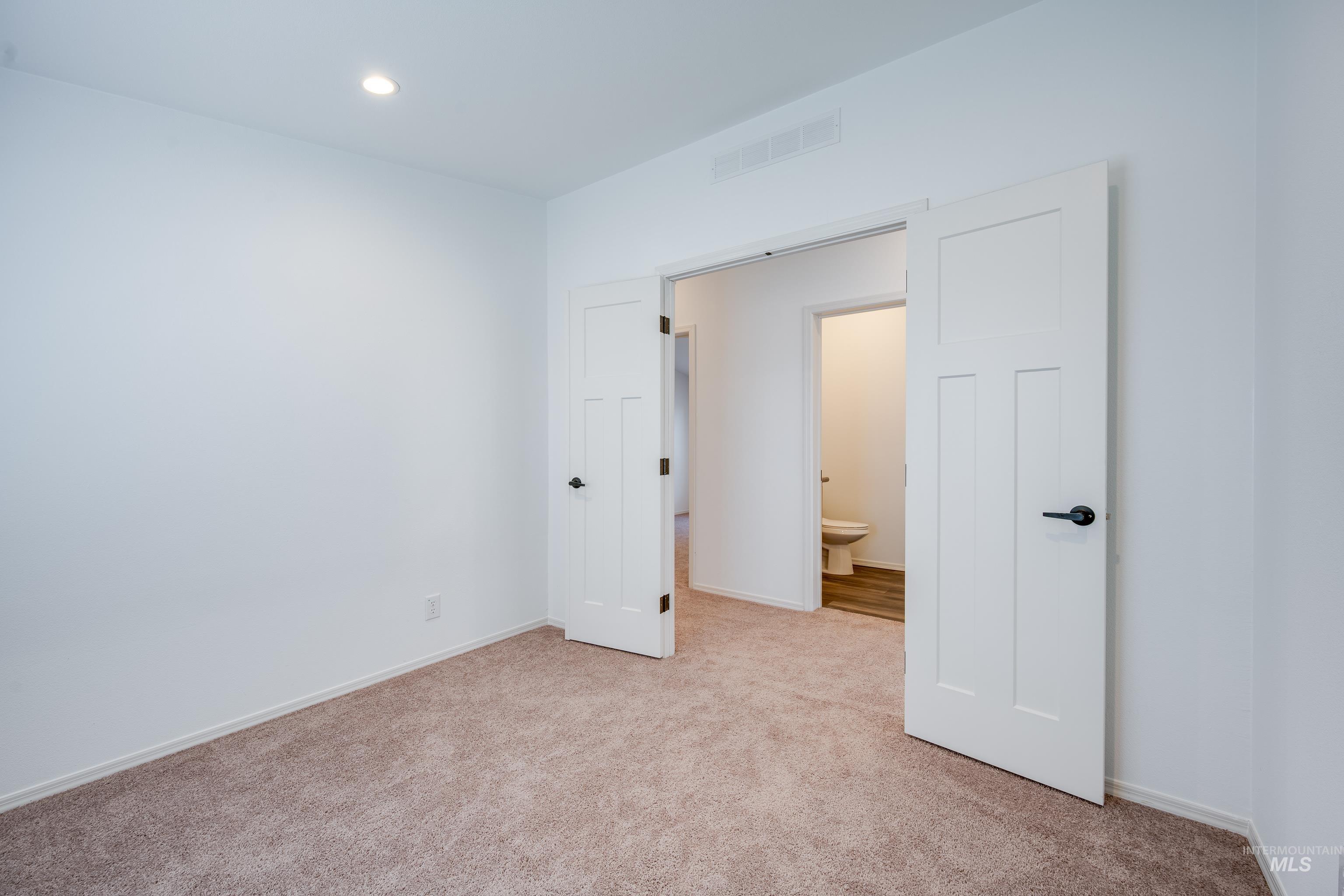 Unfurnished bedroom with carpet and recessed lighting