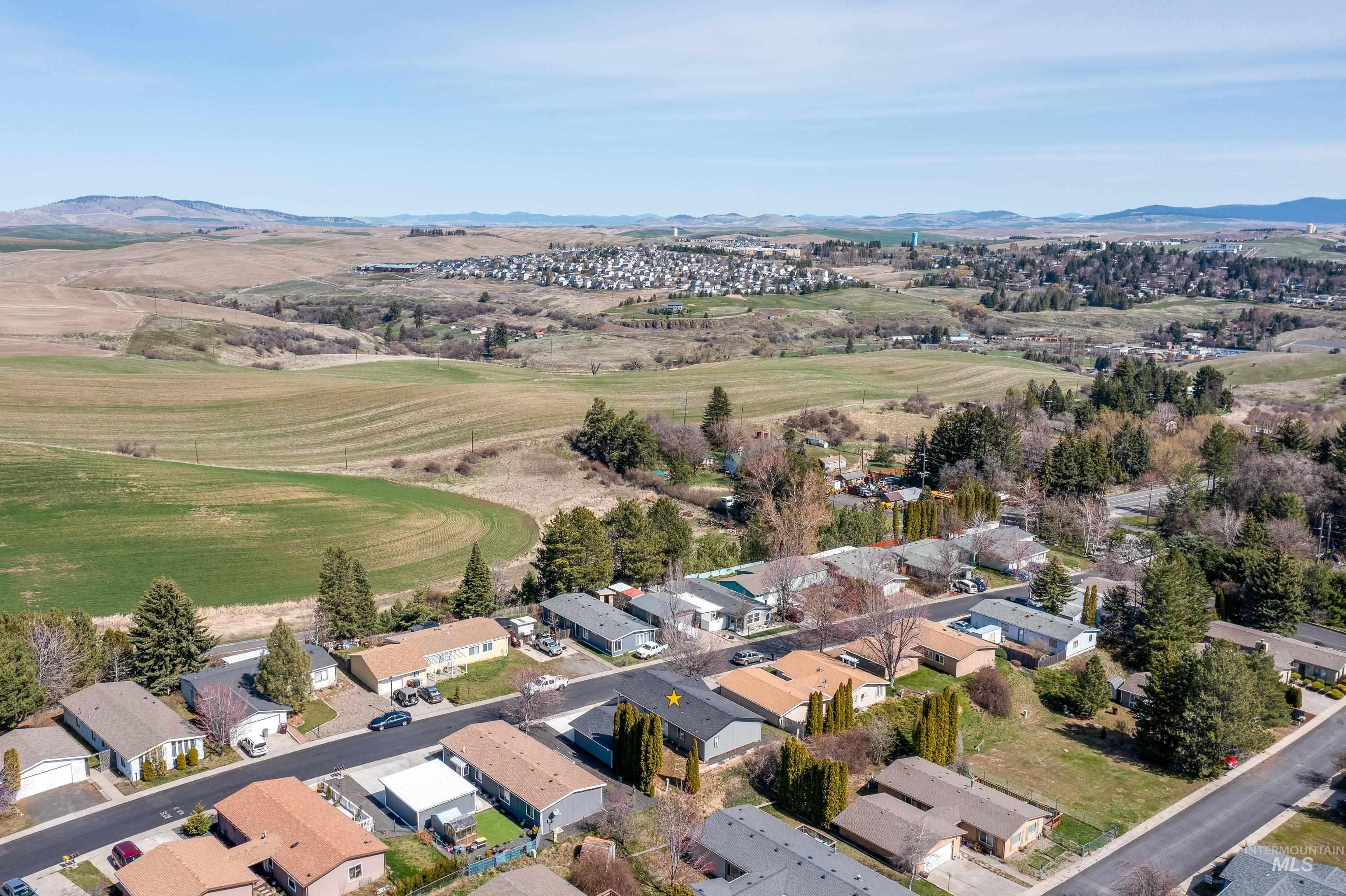 Aerial view of residential area featuring a mountain backdrop