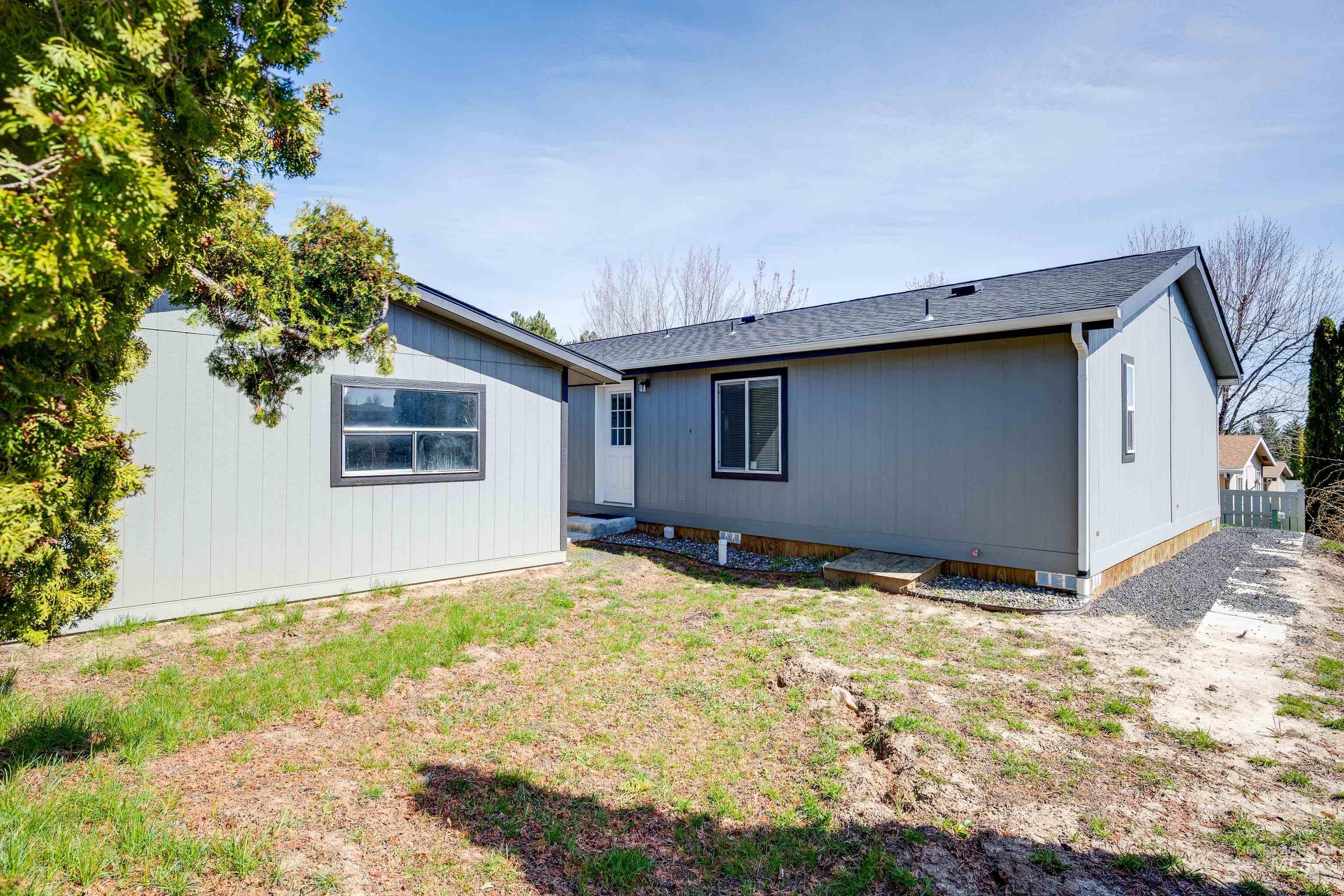Back of property featuring a shingled roof