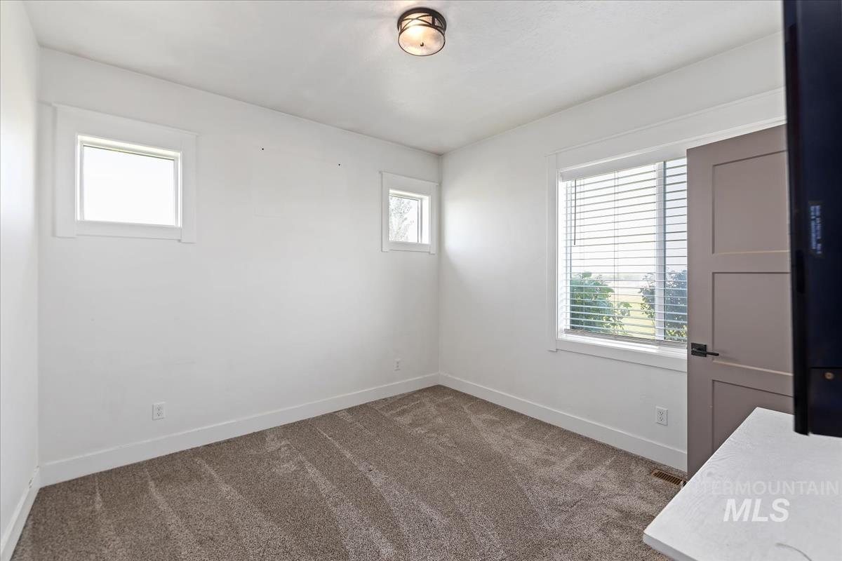 Unfurnished room with carpet and baseboards