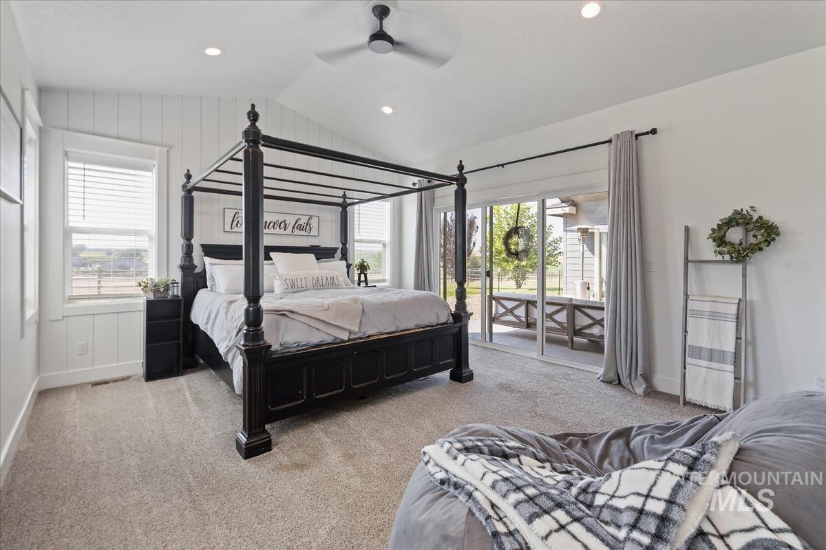 Bedroom featuring access to outside, carpet floors, vaulted ceiling, a ceiling fan, and recessed lighting