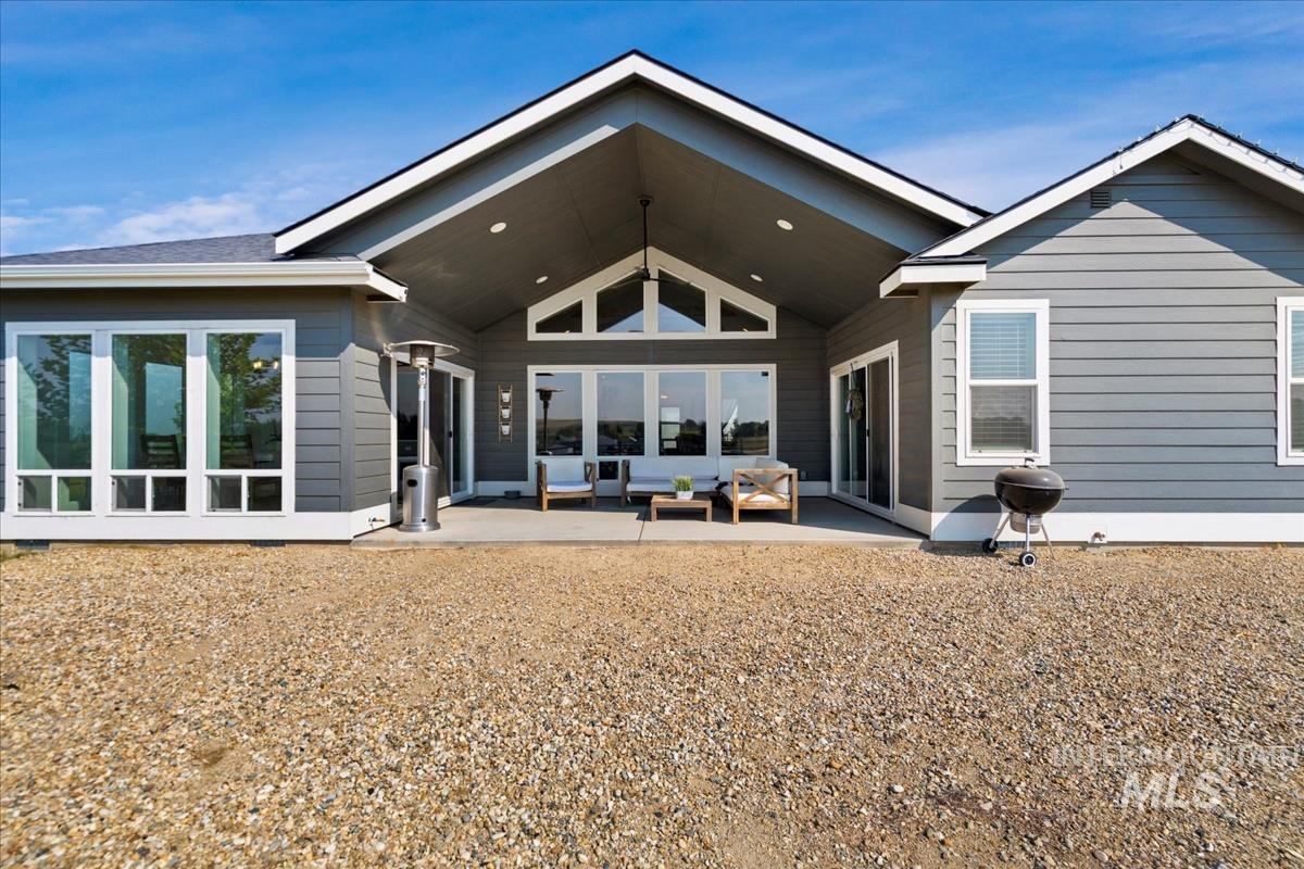 Rear view of house with a patio area and outdoor lounge area