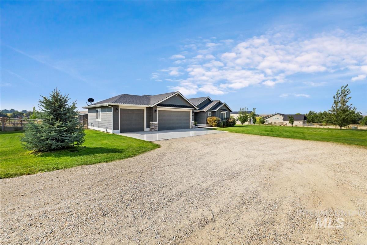 View of front of property with driveway and an attached garage
