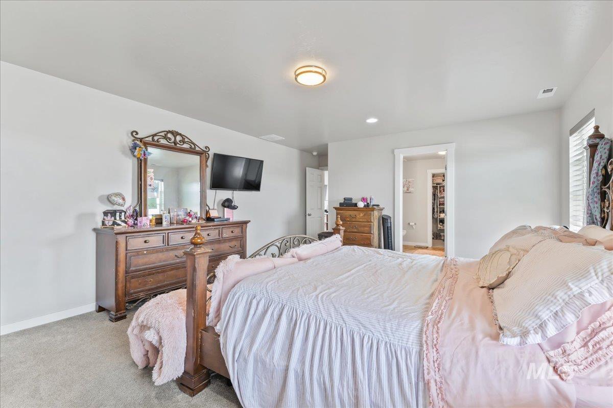 Carpeted bedroom with baseboards