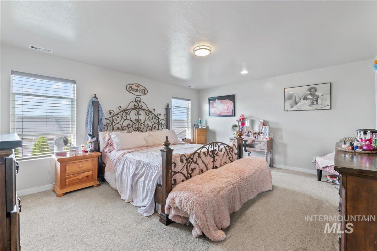 Bedroom featuring carpet floors and baseboards