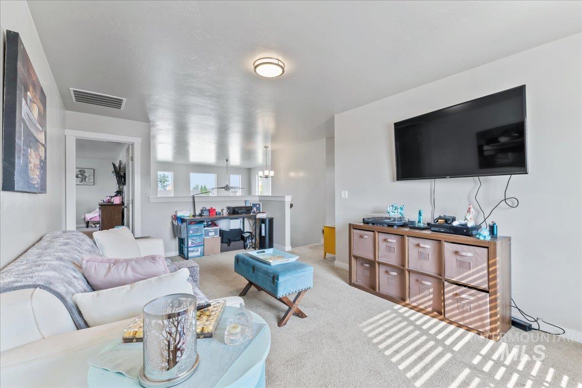 Living room featuring carpet and baseboards