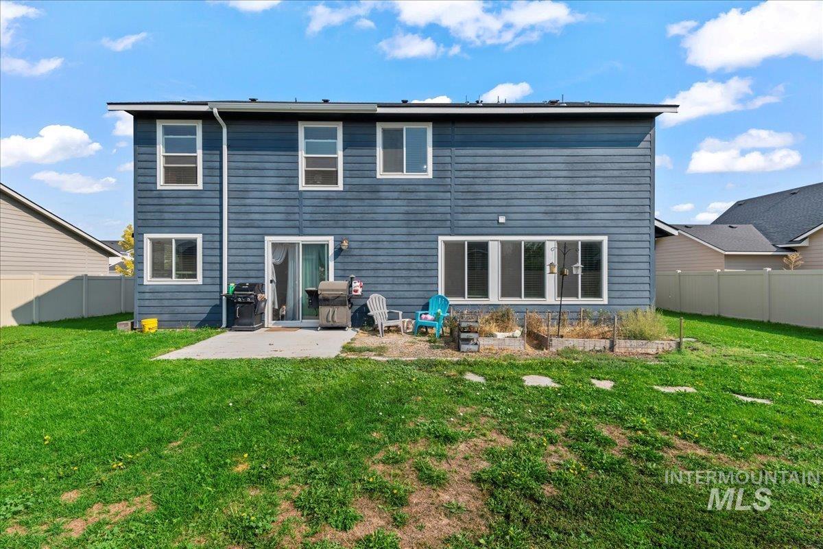 Back of property with a patio area and a fenced backyard