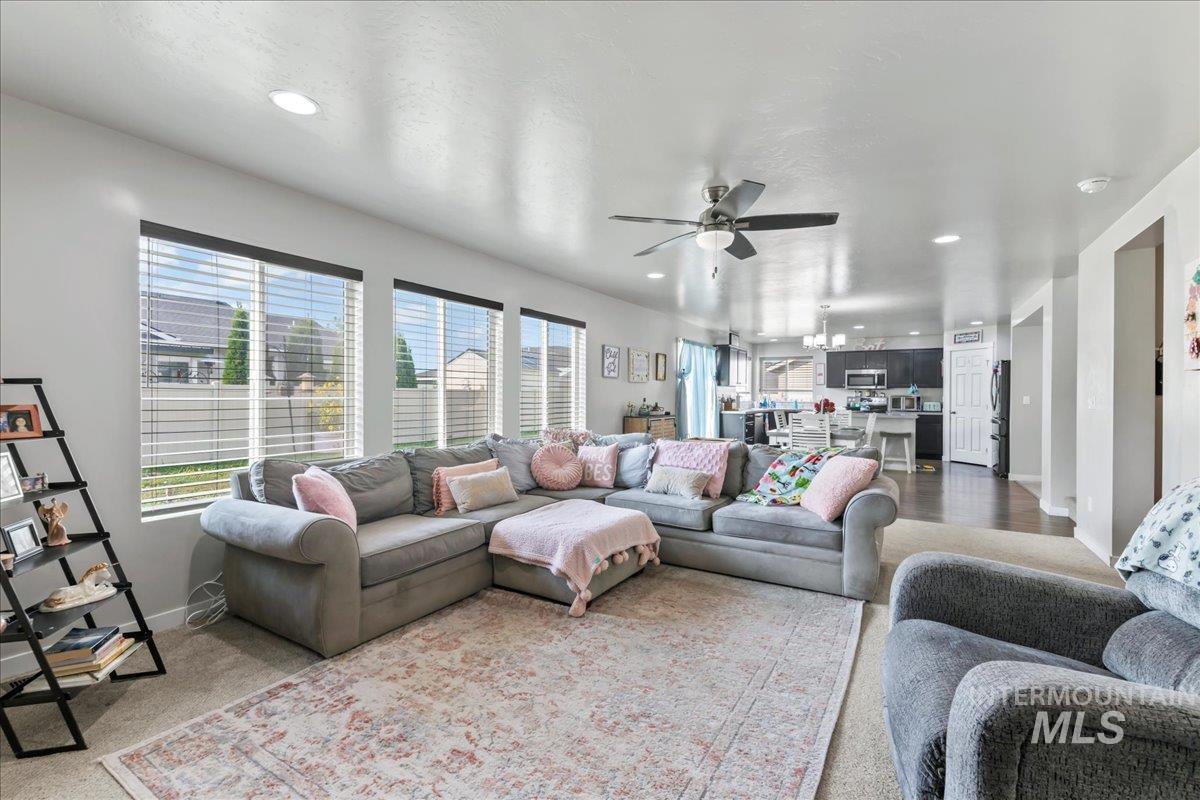 Living room featuring recessed lighting and a ceiling fan