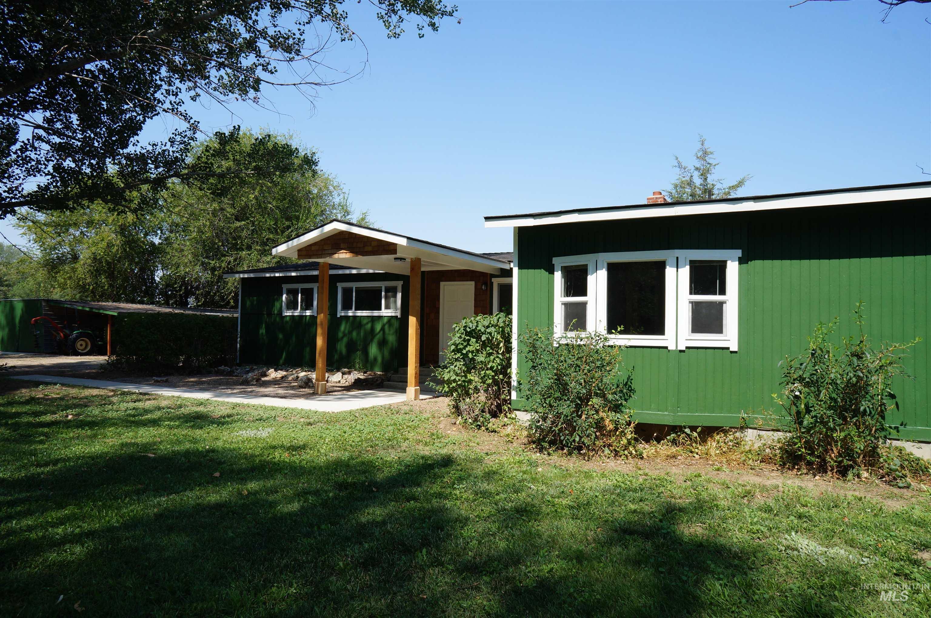Rear view of property with a yard