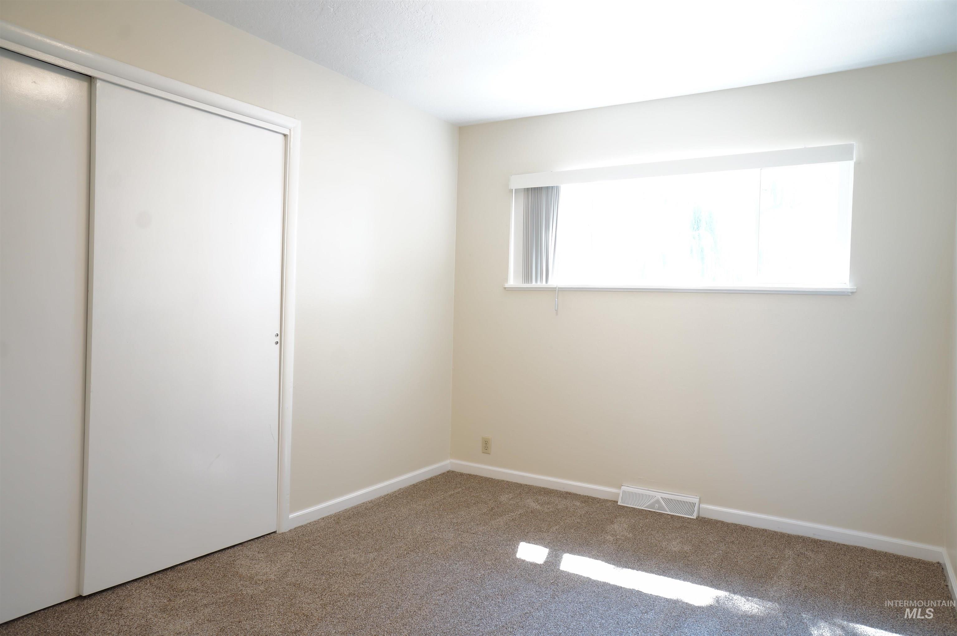 Unfurnished bedroom featuring carpet floors and a closet