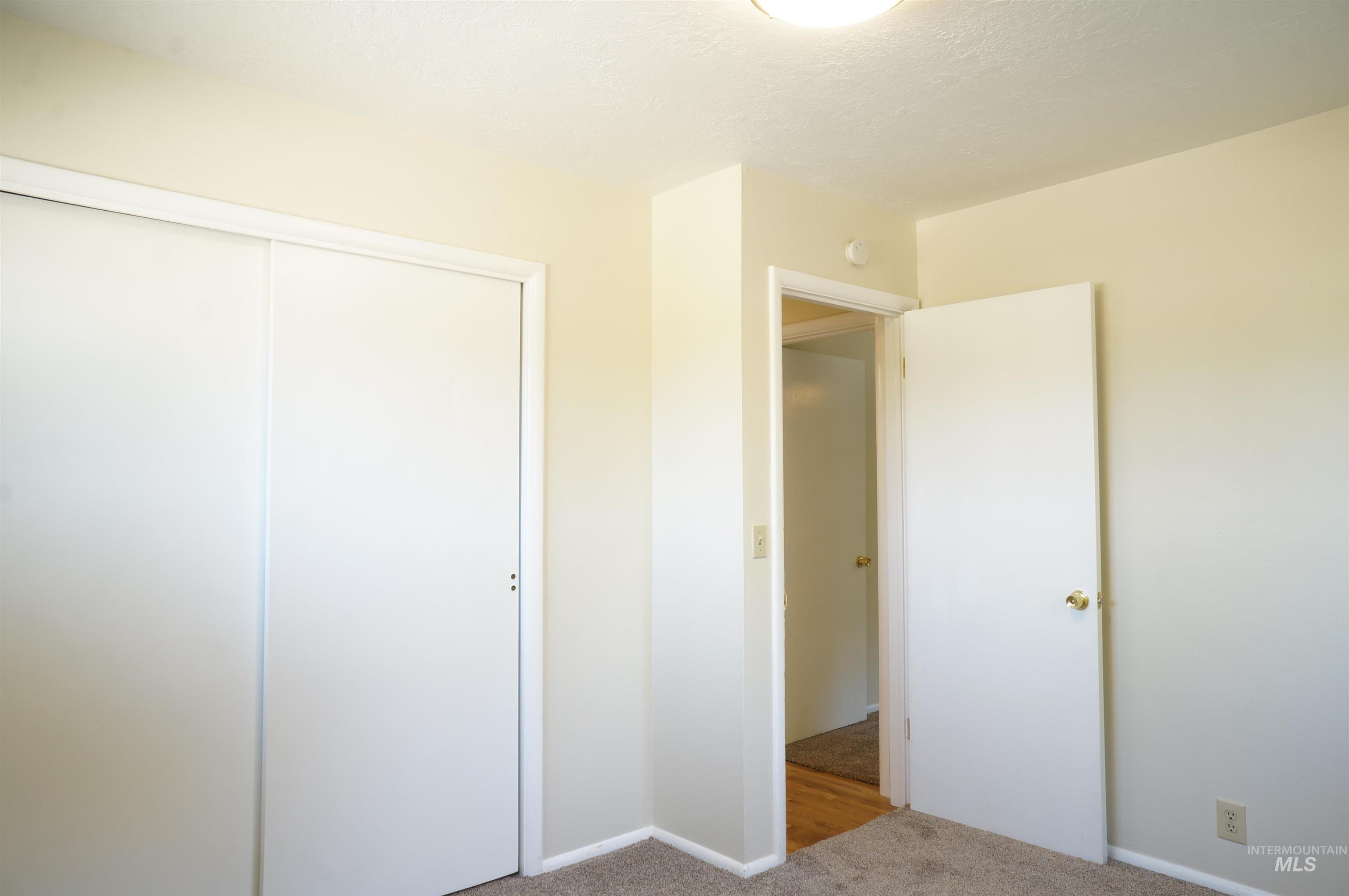 Unfurnished bedroom featuring carpet floors and a closet