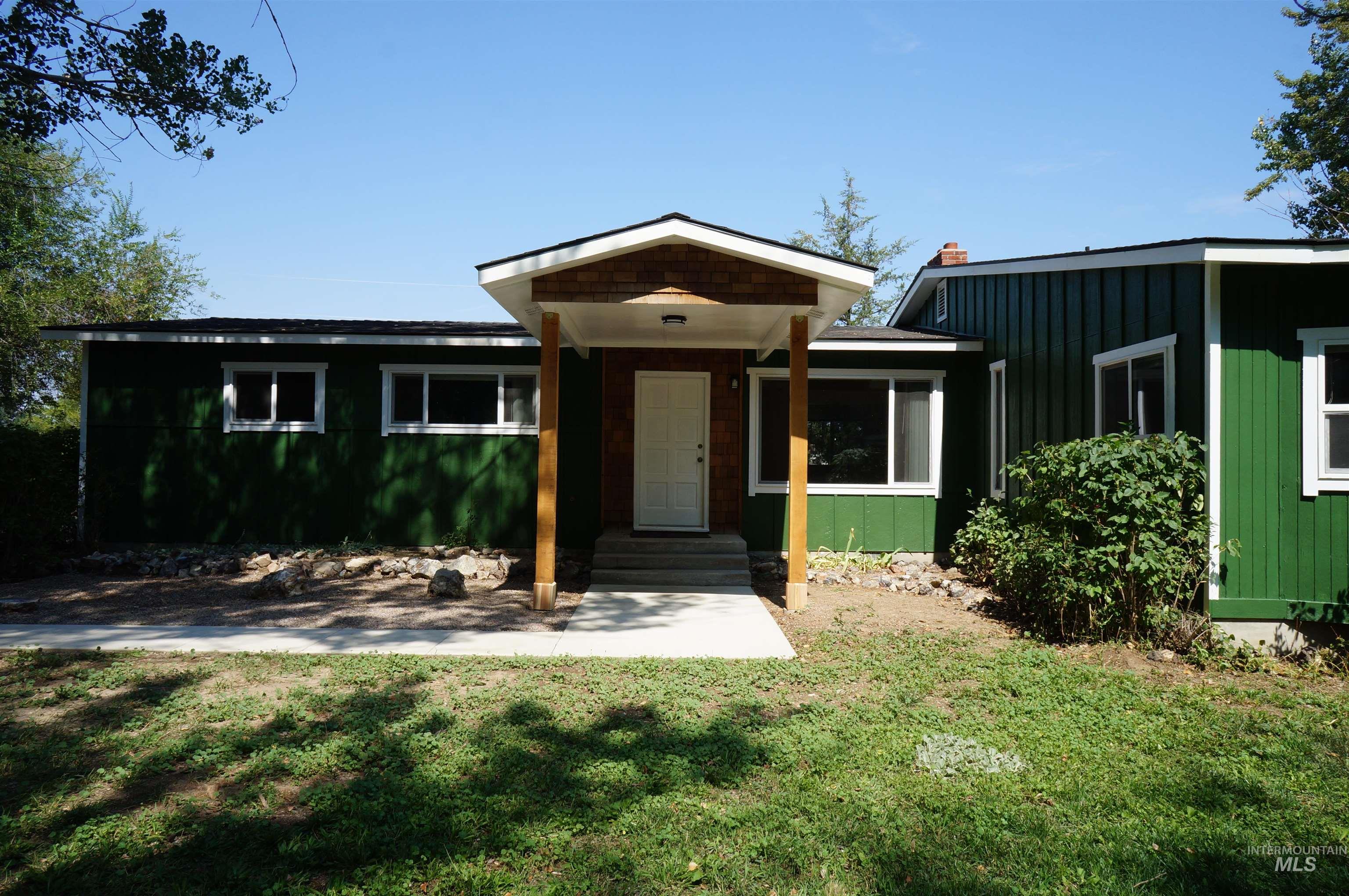 View of front of home with board and batten siding and a front lawn