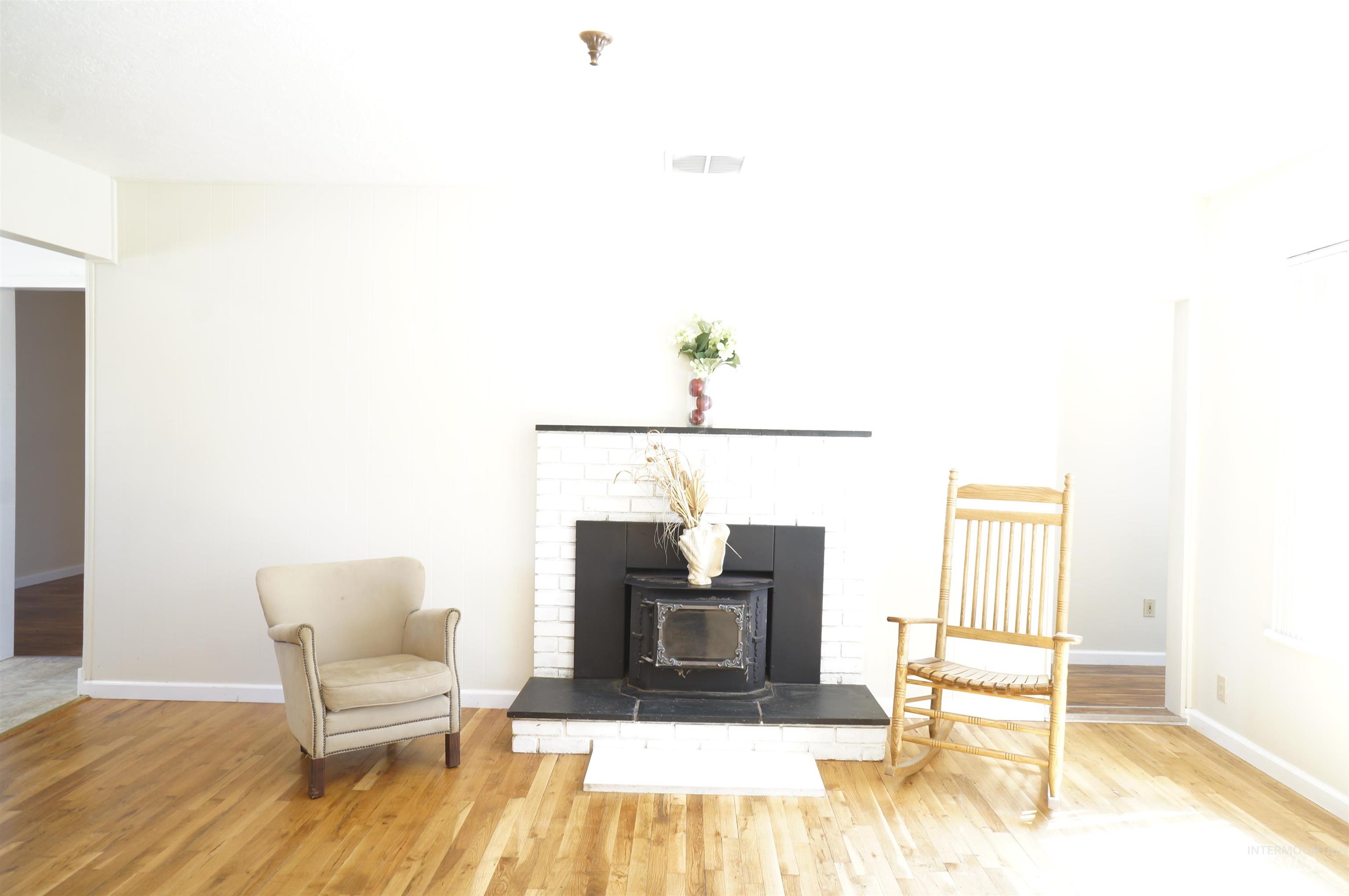 Living area featuring wood finished floors and a wood stove