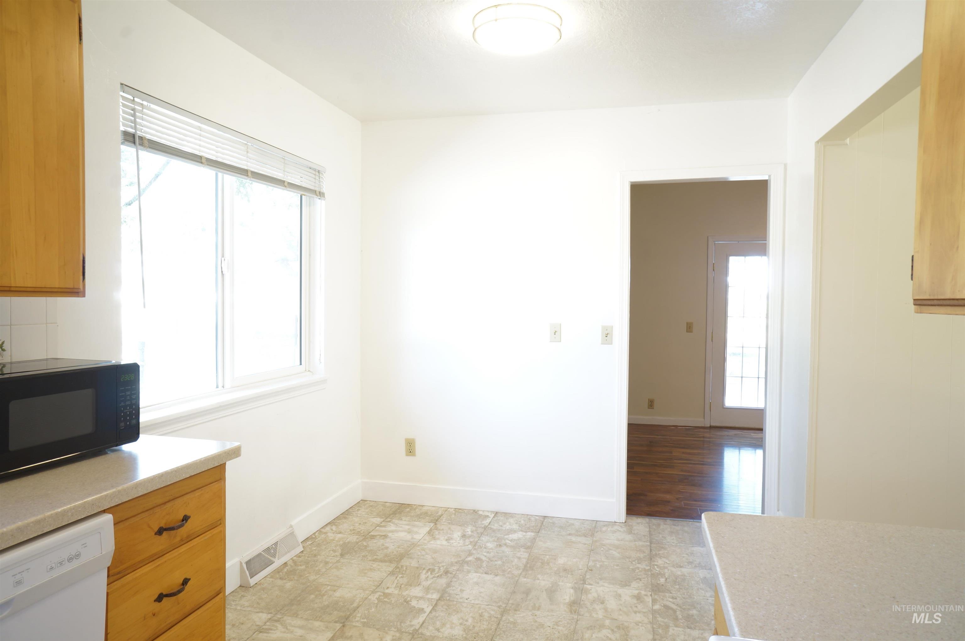 Unfurnished dining area with baseboards