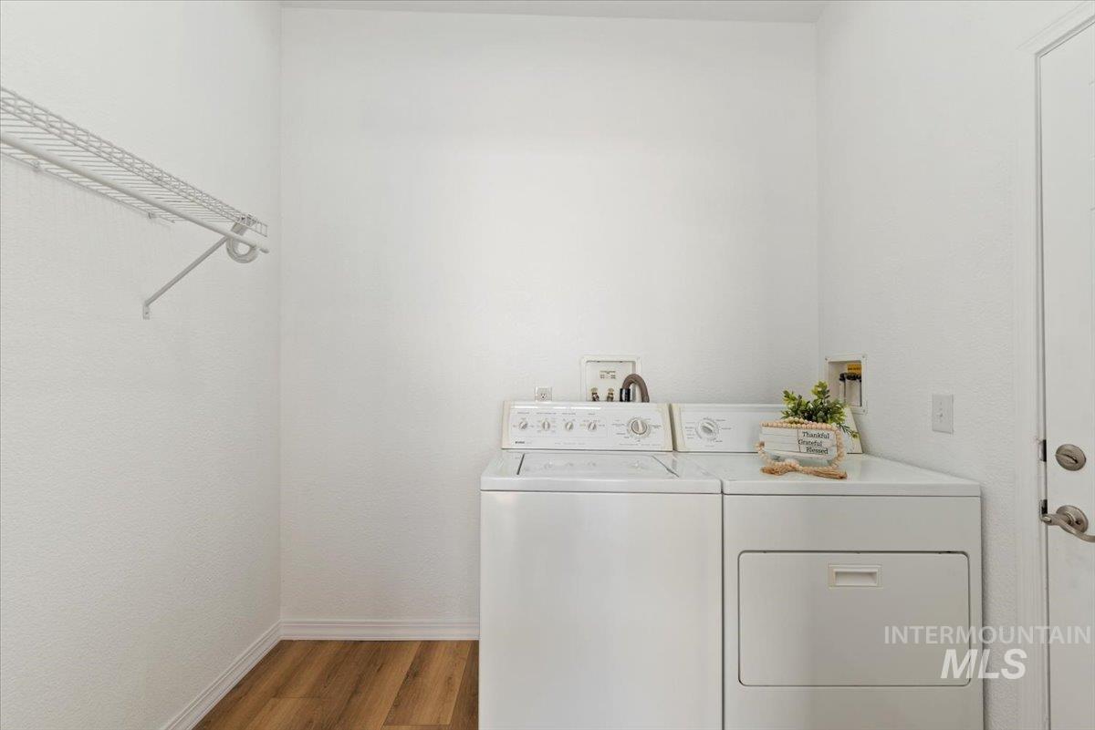 Washroom featuring dark wood finished floors and washing machine and clothes dryer
