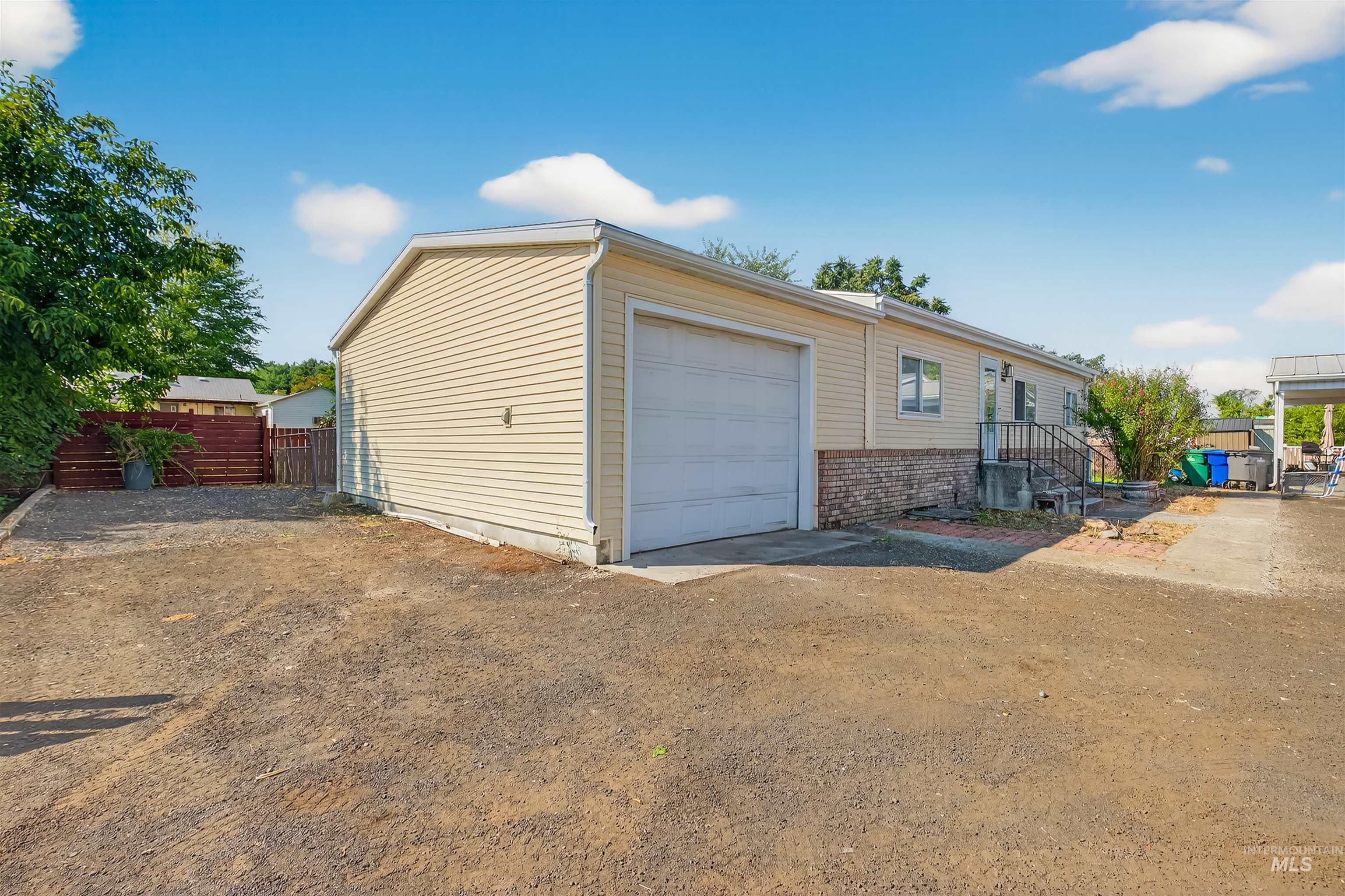 Garage with dirt driveway