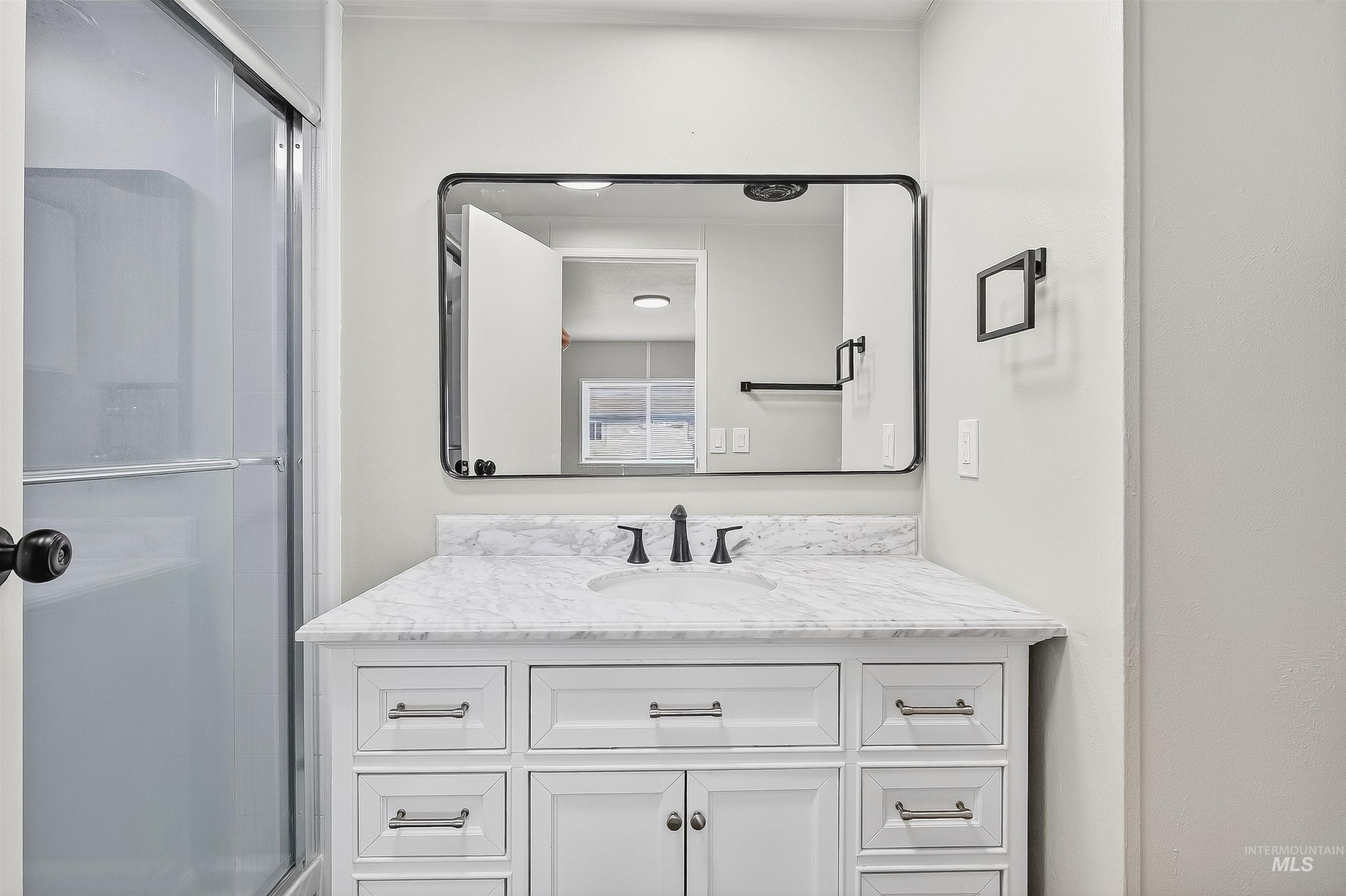 Bathroom featuring vanity and a shower stall