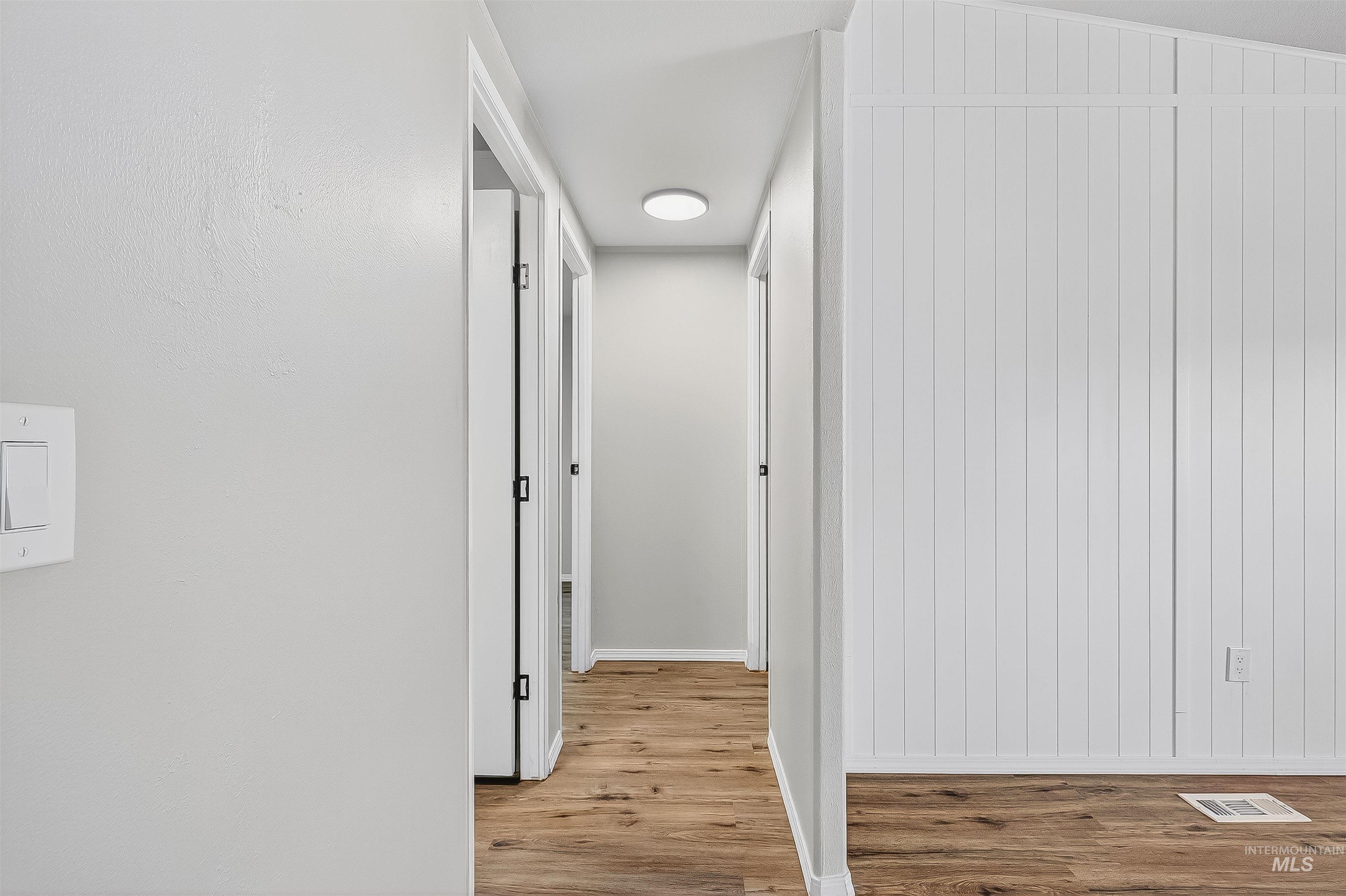 Hall featuring light wood finished floors and baseboards