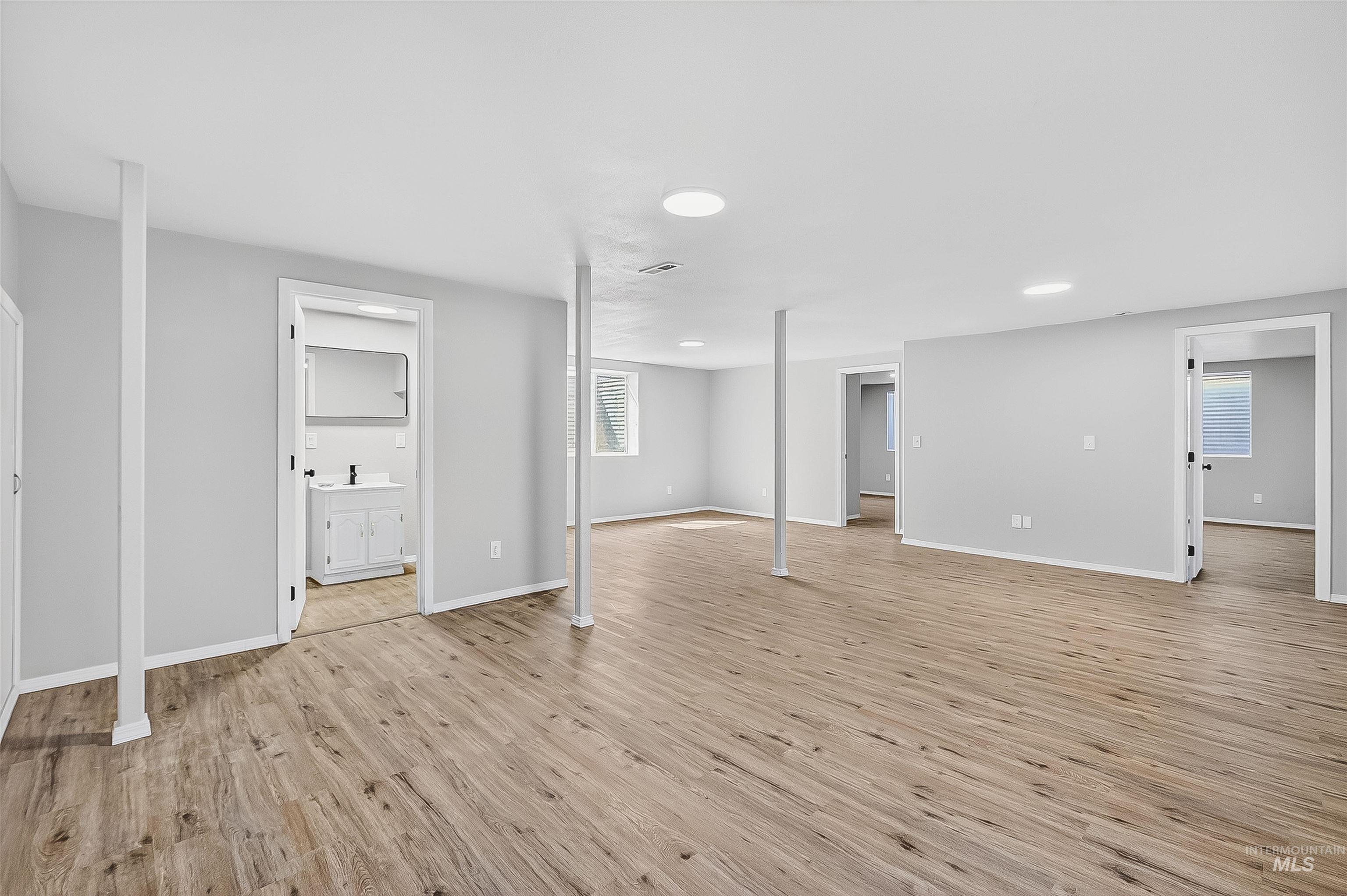 Below grade area with light wood-type flooring and baseboards