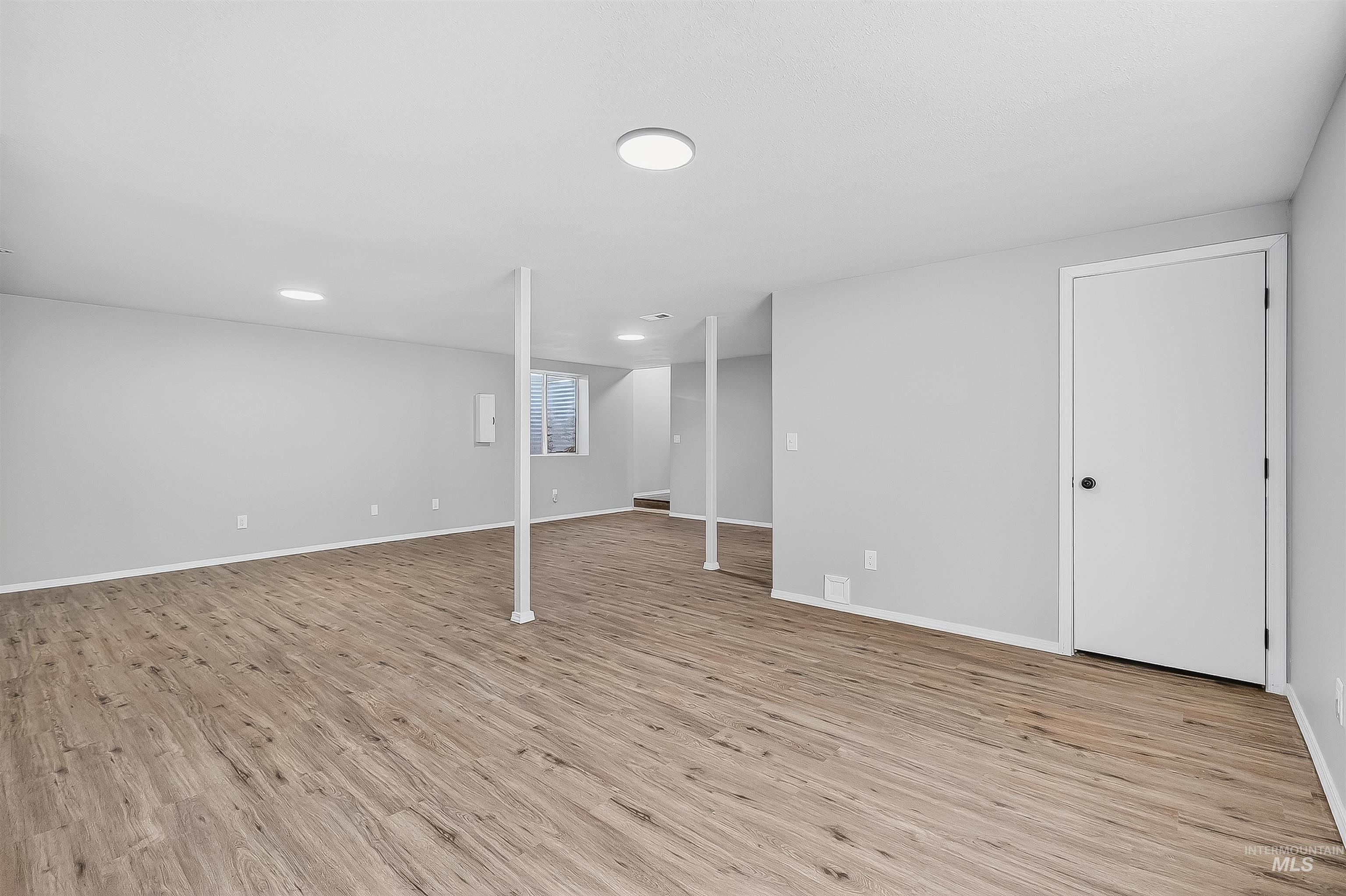 Finished basement featuring light wood-type flooring and baseboards