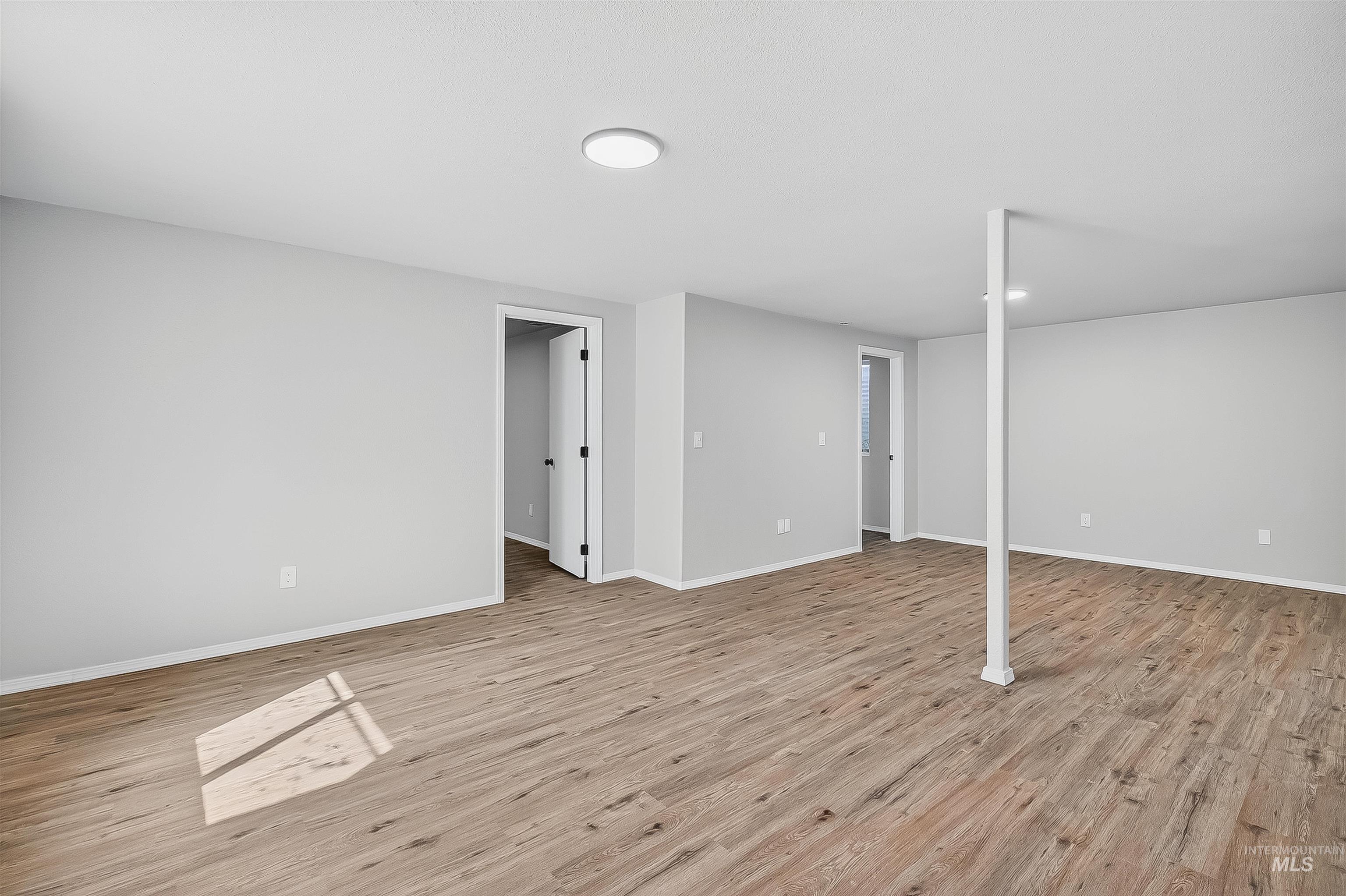 Finished below grade area with light wood finished floors and baseboards