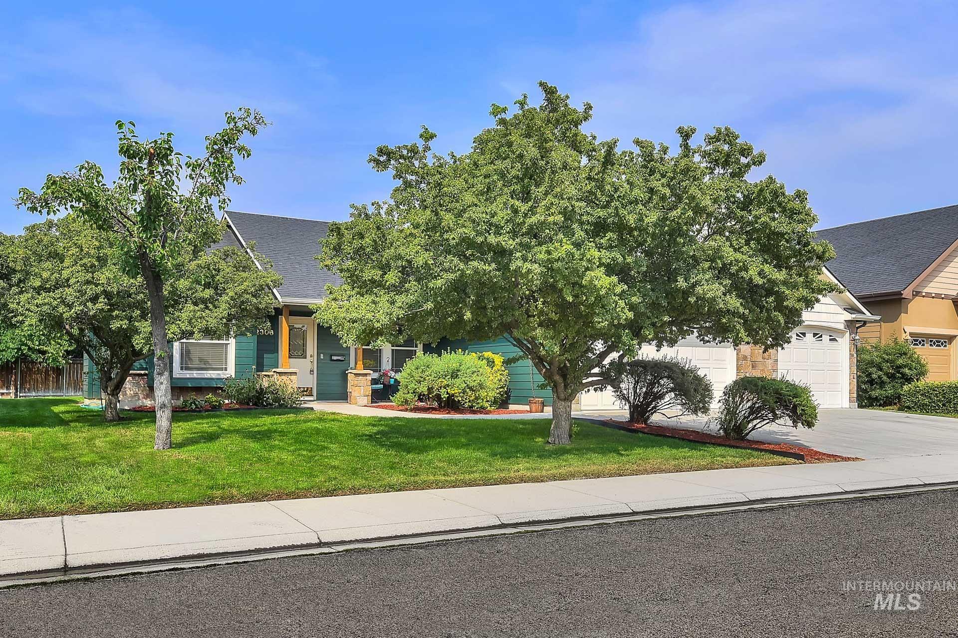 View of property with gorgeous established shade trees, south facing driveway that helps melt off that snow and ice in the winter!