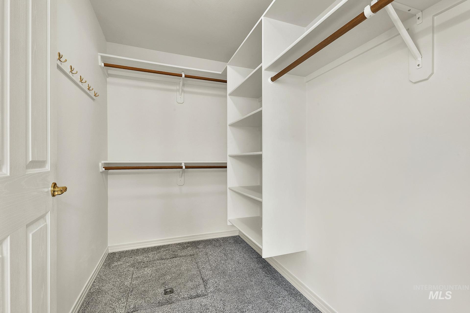 View of walk in closet with ample shelves and plenty of room for your wardrobe