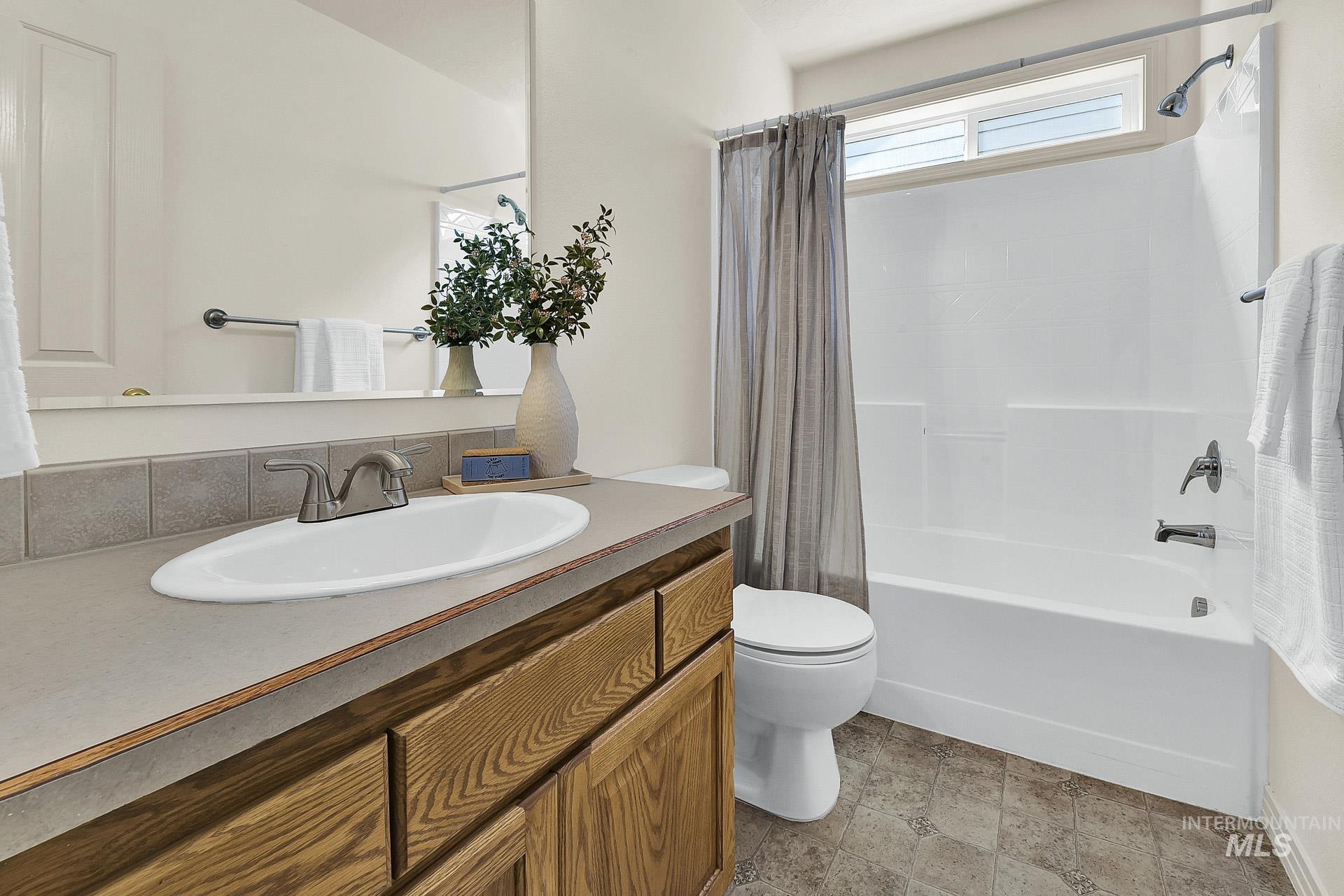 Main Full bath featuring shower / bath combo and vanity