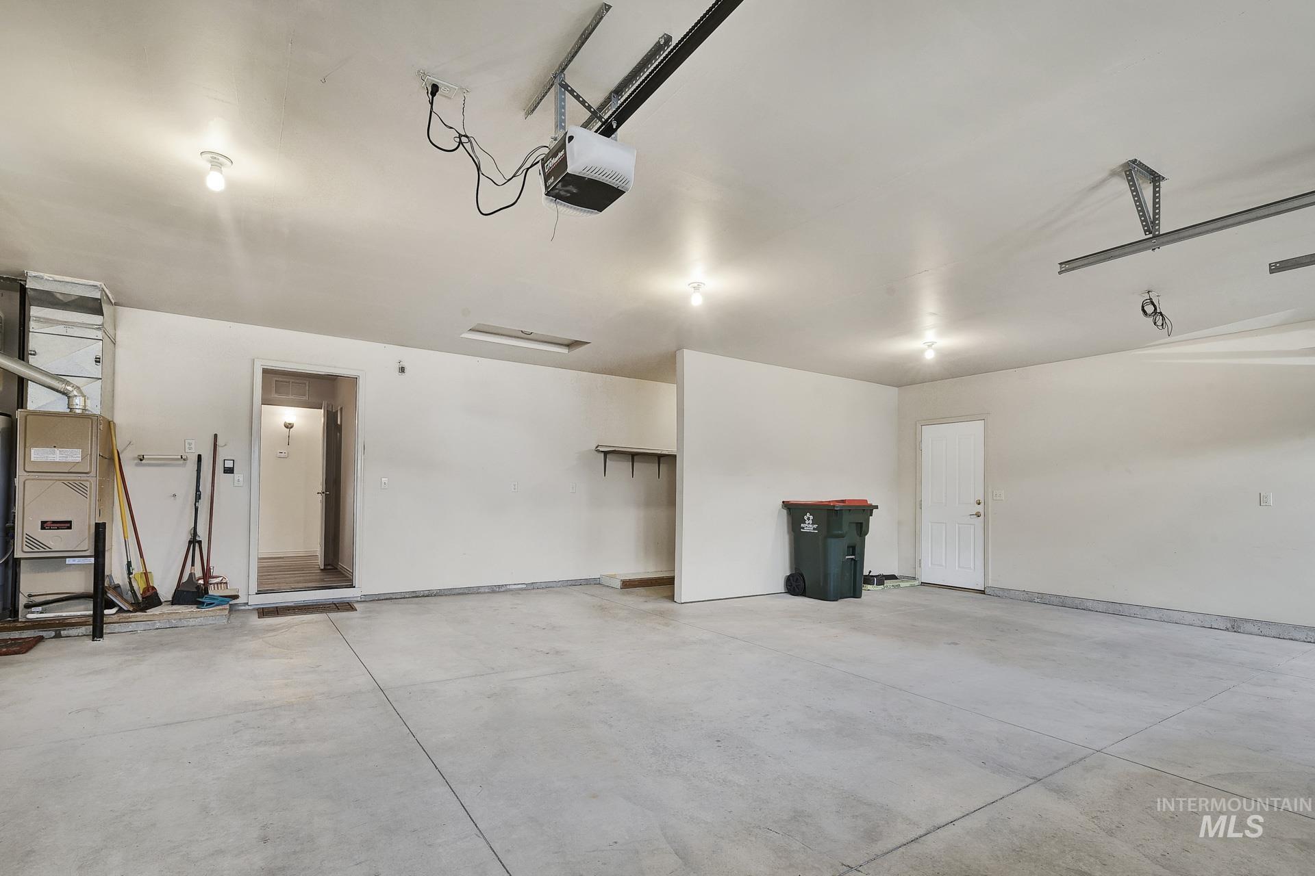 Spacious oversized 3 car Garage ideal for parking and projects!  Privacy wall with plenty of room for a workbench for your hobbies and tools or extra storage.
