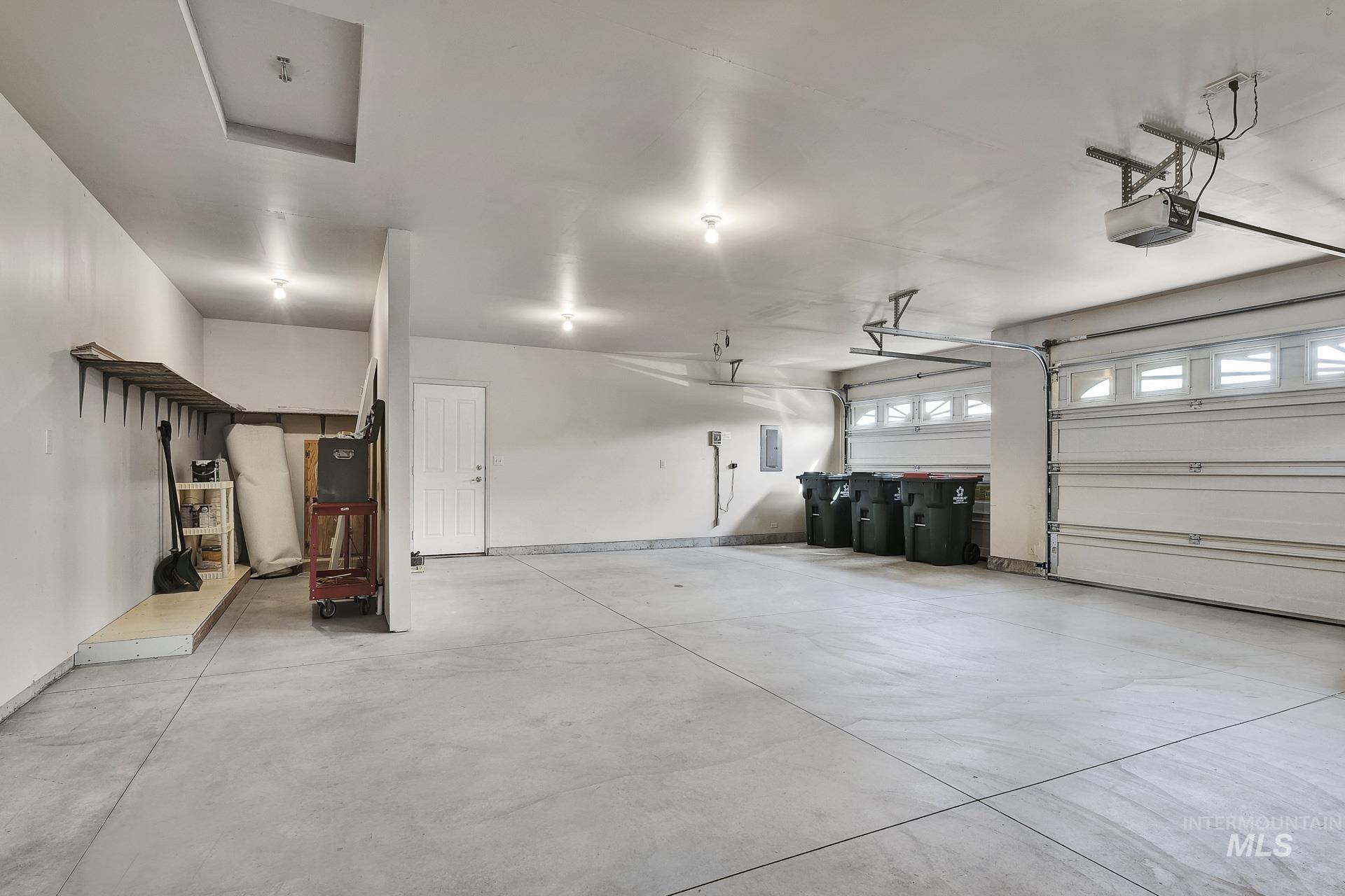 Spacious oversized 3 car Garage ideal for parking and projects!  Privacy wall with plenty of room for a workbench for your hobbies and tools or extra storage.