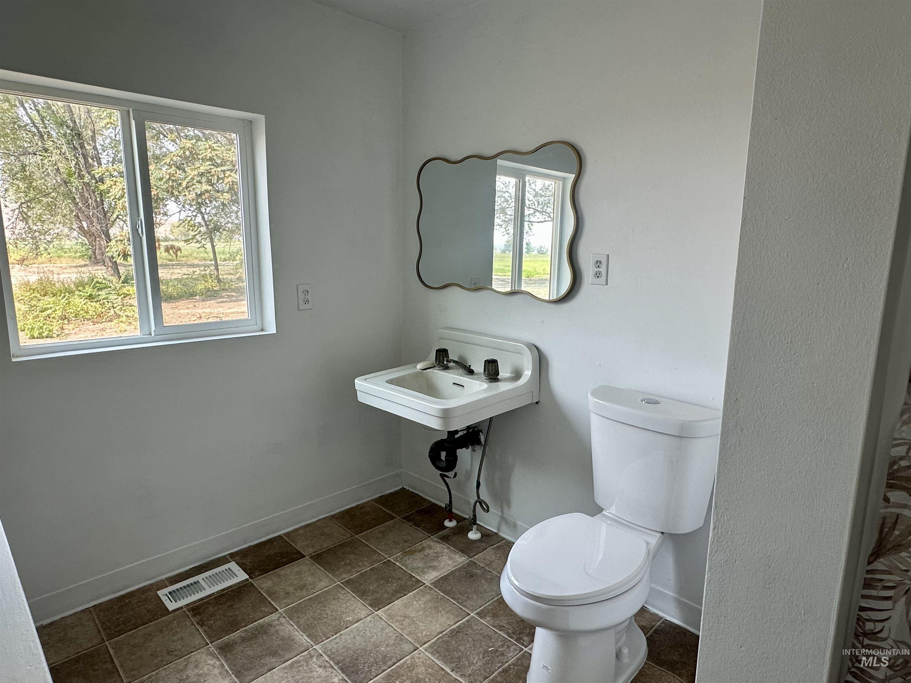 Bathroom with toilet and baseboards