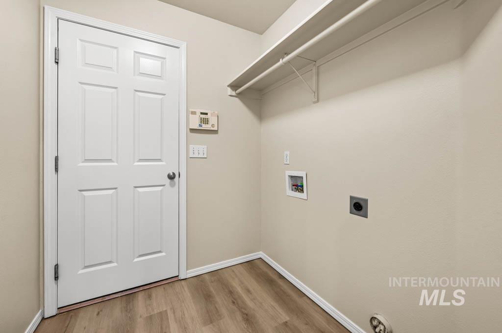 Laundry area featuring electric dryer hookup, light wood-style flooring, and hookup for a washing machine