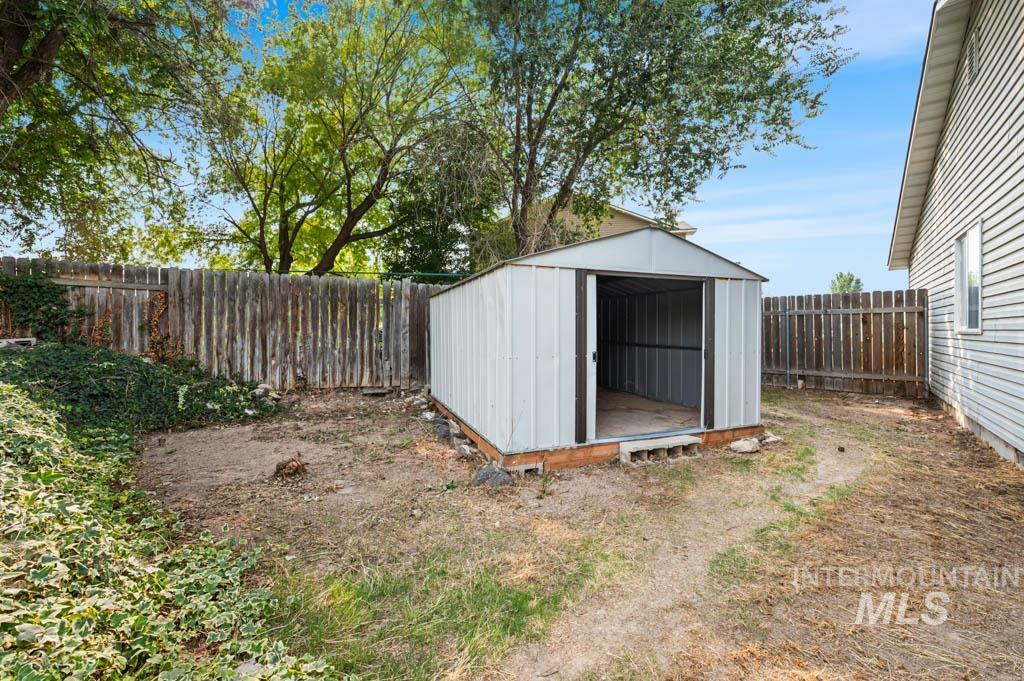 View of shed featuring a fenced backyard