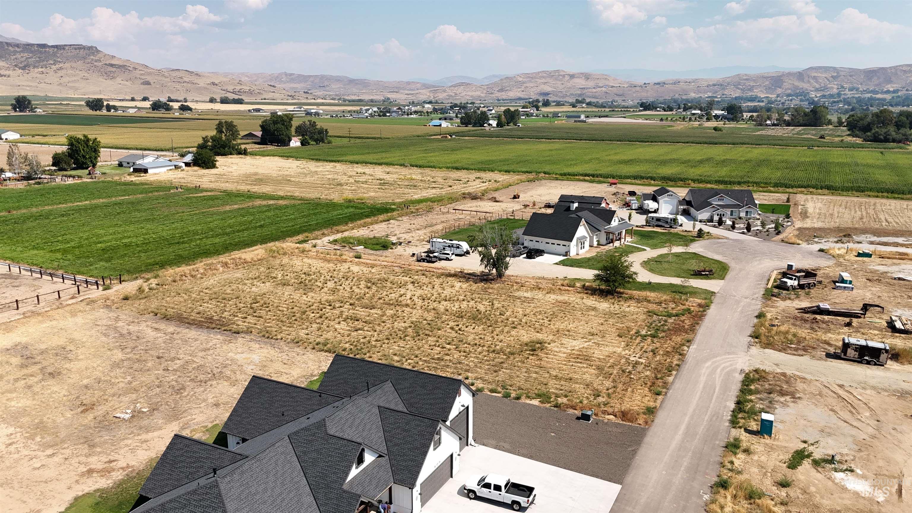 View of rural area featuring a mountain backdrop and farmland