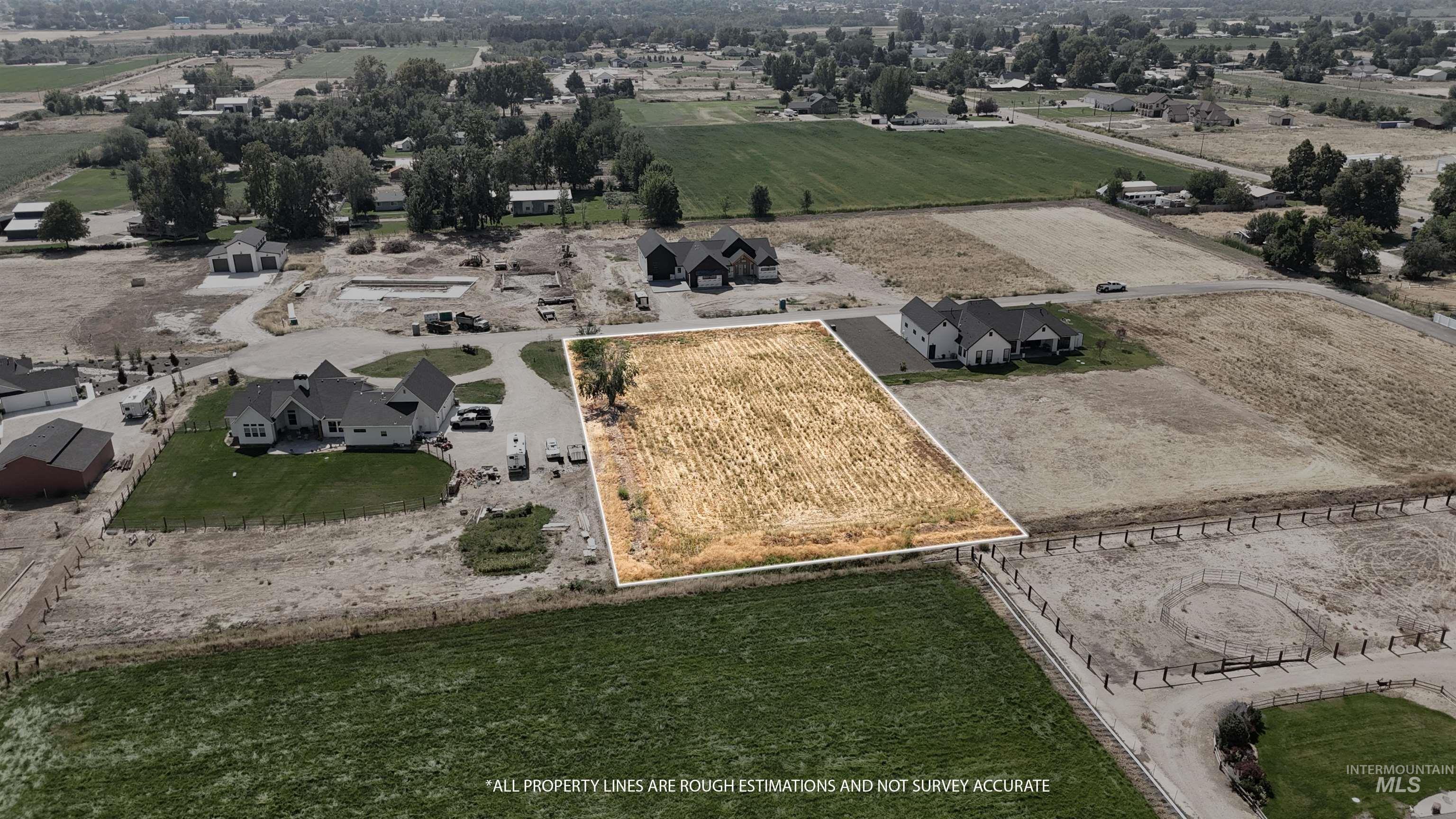 Aerial view of sparsely populated area with nearby suburban area and property parcel outlined