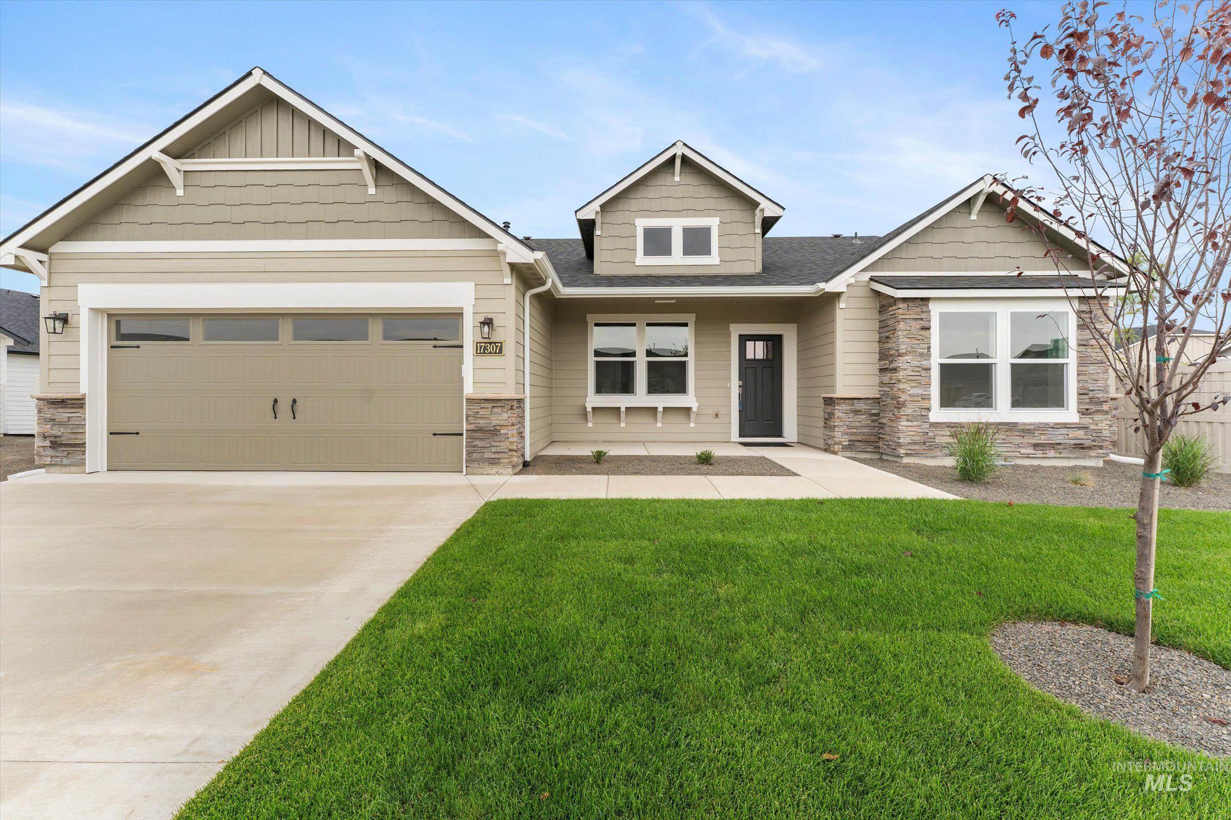 Craftsman inspired home with stone siding, concrete driveway, a porch, a front yard, and a garage