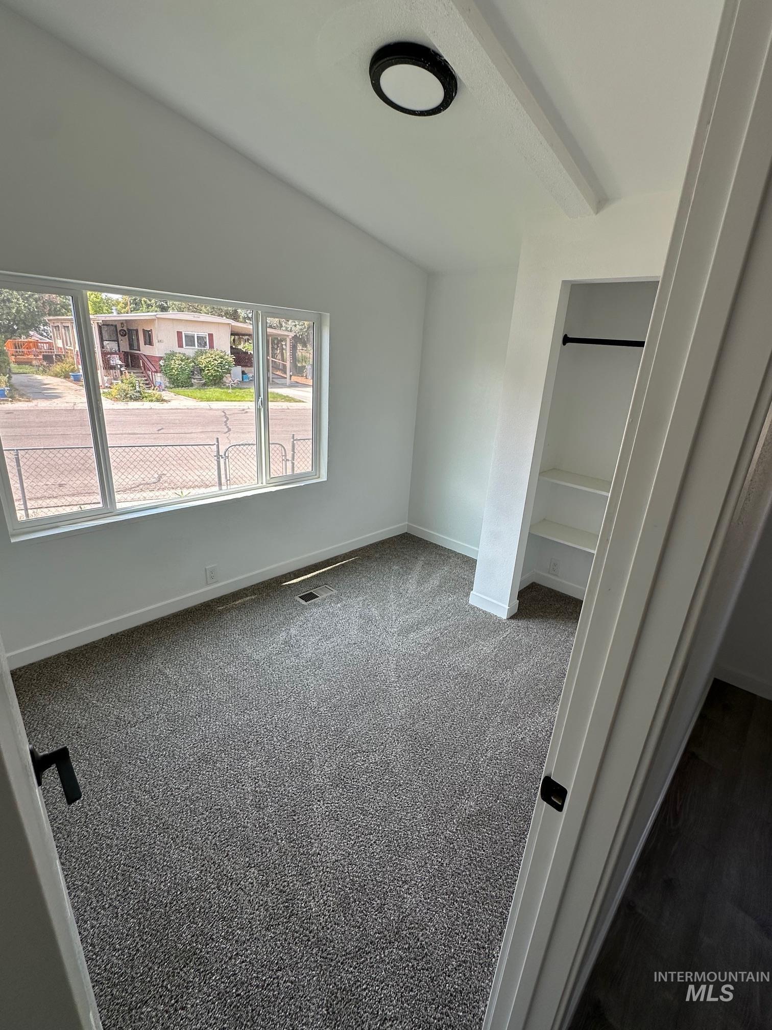 Unfurnished bedroom featuring carpet and baseboards