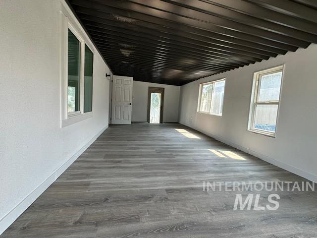 Unfurnished living room featuring wood finished floors