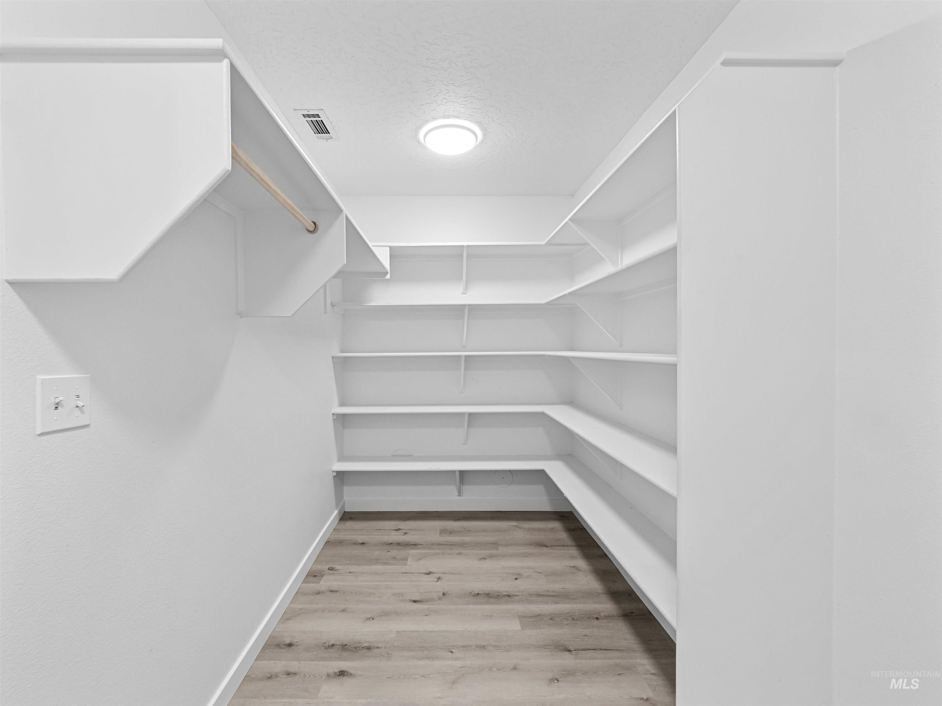 Walk in closet featuring light wood-type flooring