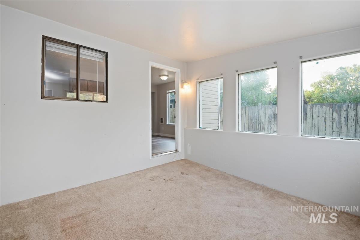 Carpeted empty room with healthy amount of natural light