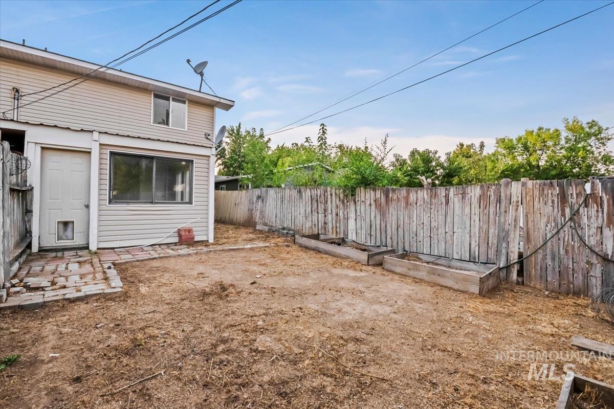 Fenced backyard featuring a patio and a garden