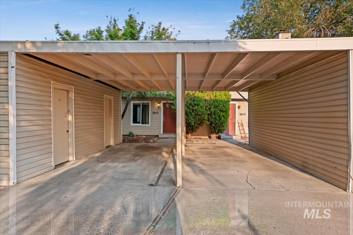View of patio featuring an attached carport and driveway