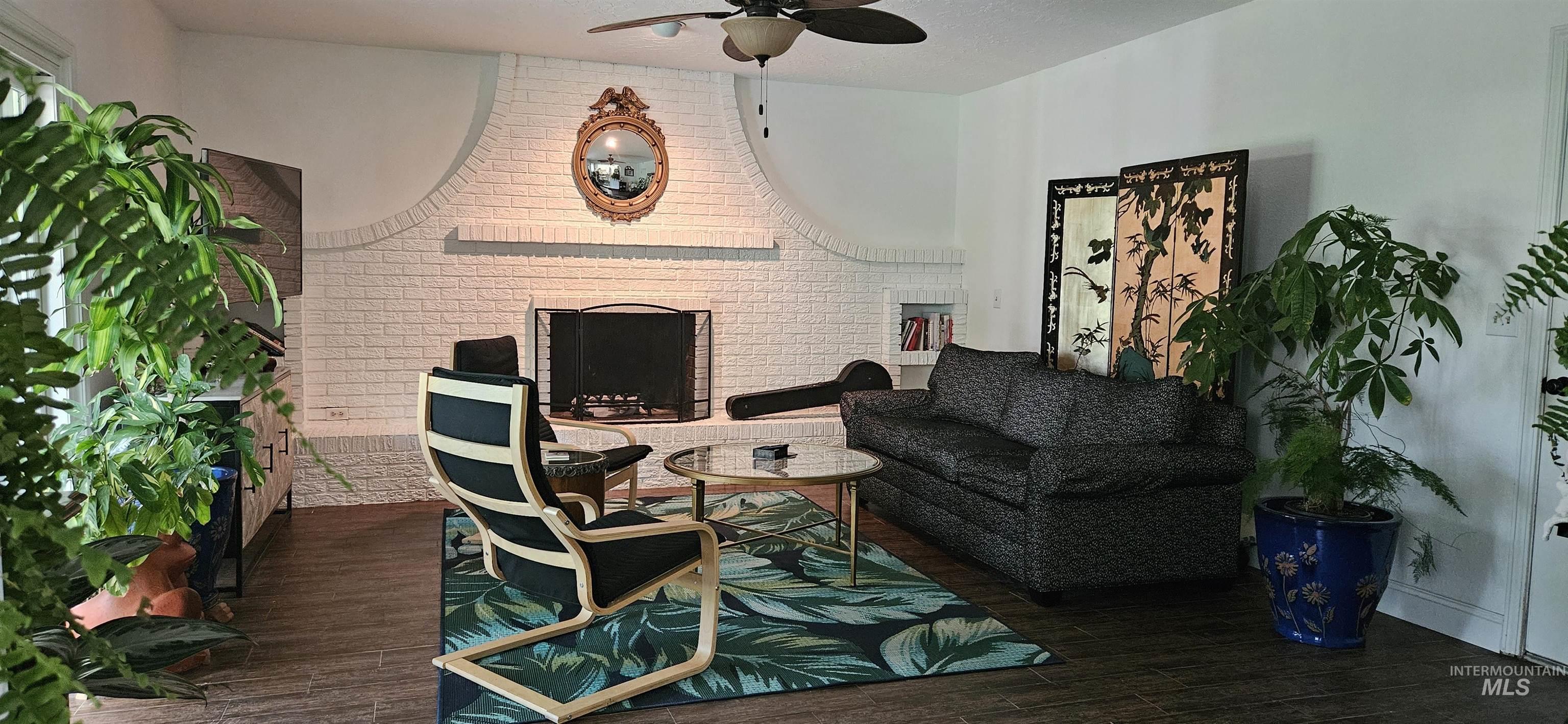 Family Room with floor to ceiling wall to wall fireplace/bookcase, glass  double pained sliding door leading to covered patio, designer Casablanca ceiling fan, designer textured ceiling, full GOLF COURSE VIEW