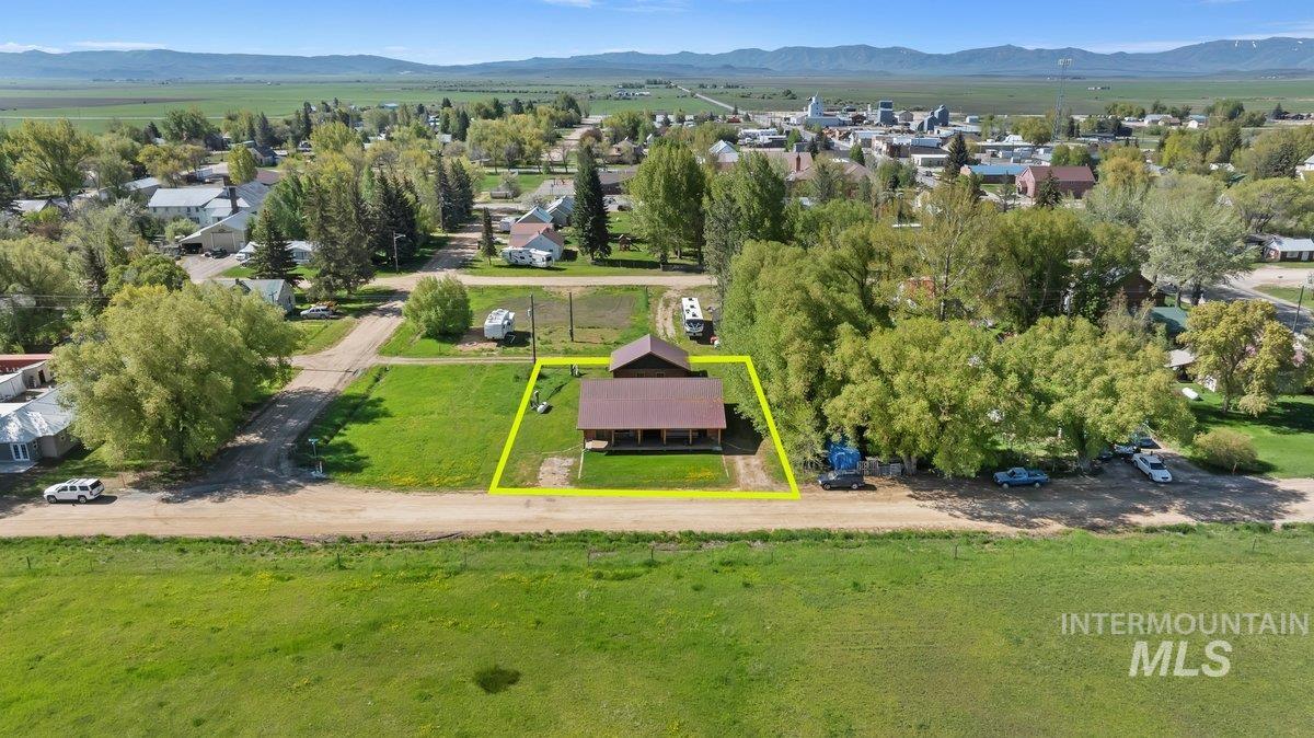 Aerial perspective of suburban area with a mountainous background and property boundaries highlighted
