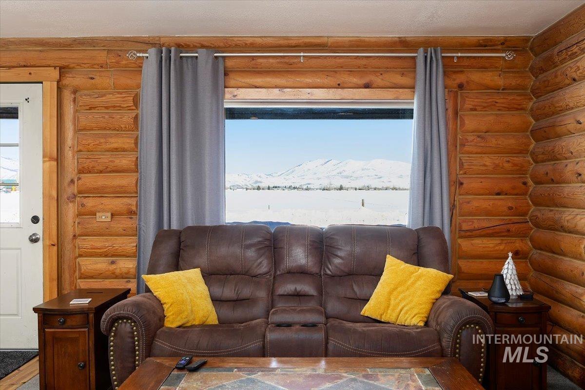 Living area with rustic walls and healthy amount of natural light