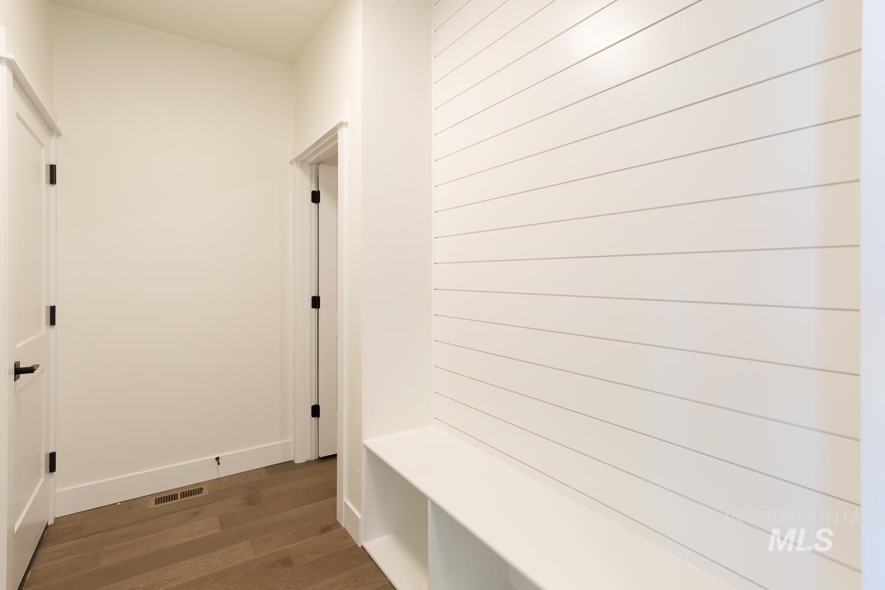 Mudroom with dark wood-style floors and baseboards